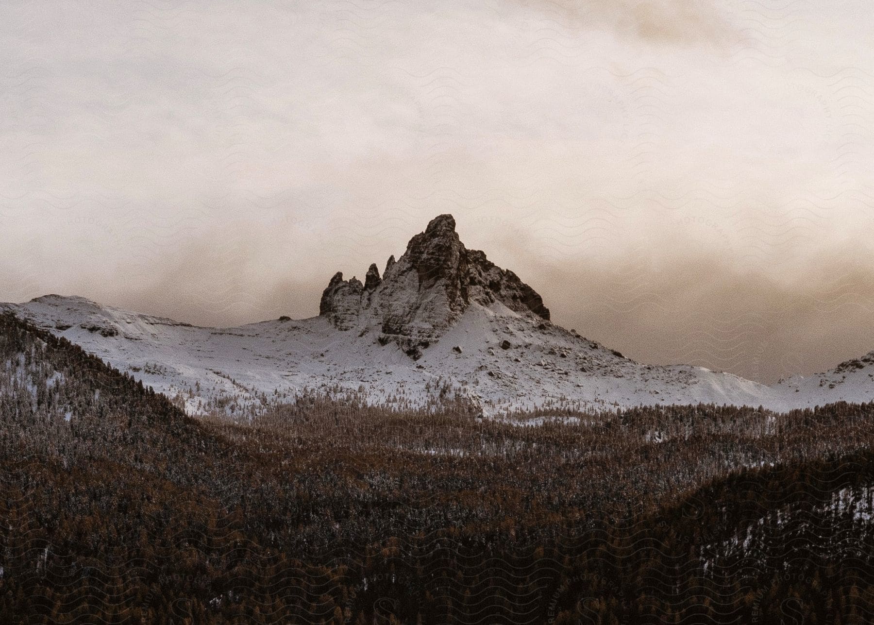 A view of a mountain with some snow on it in the distance.