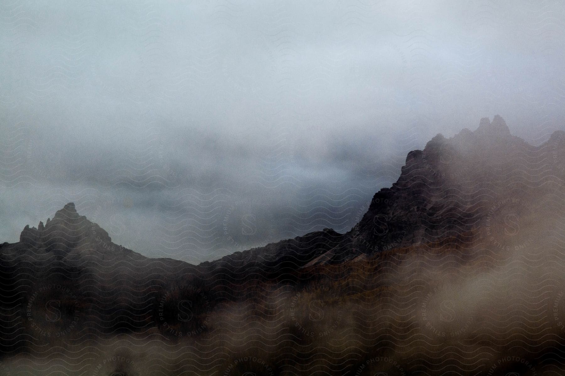 A mountain with two peaks in a foggy region and it is dark