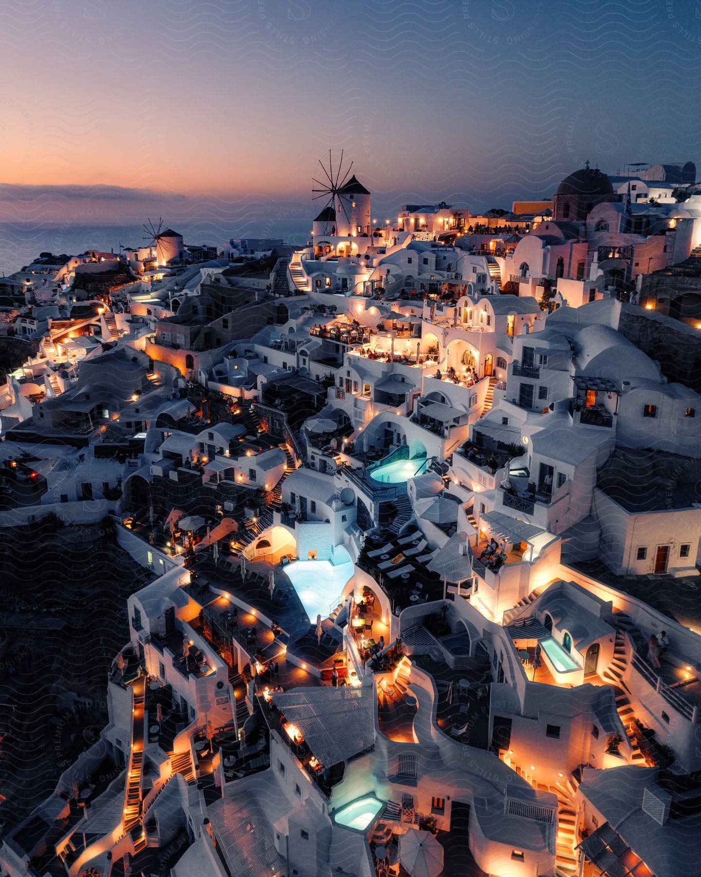 Lights glowing on buildings on the Greek island Santorini at blue hour