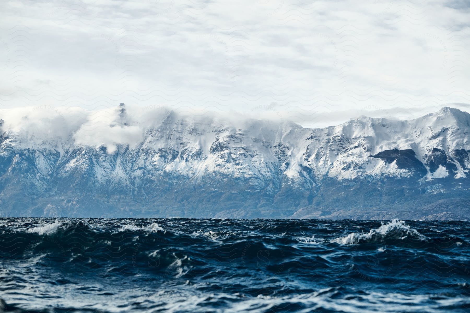 Ocean waves near an ice covered mountain shore