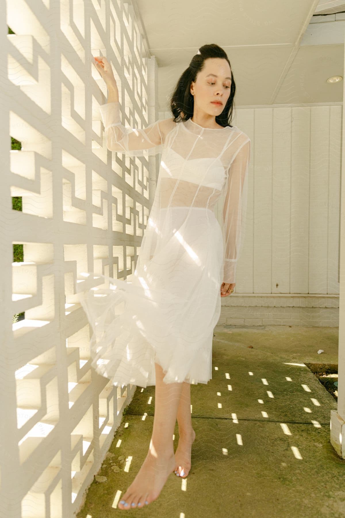 a young lady wearing white clothes indoor