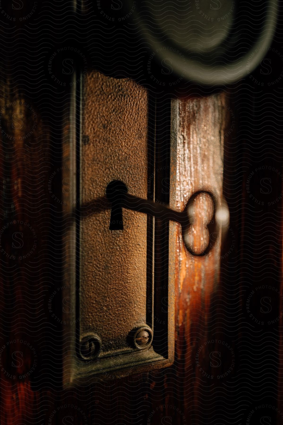A skeleton key is inside the lock of a door of a house