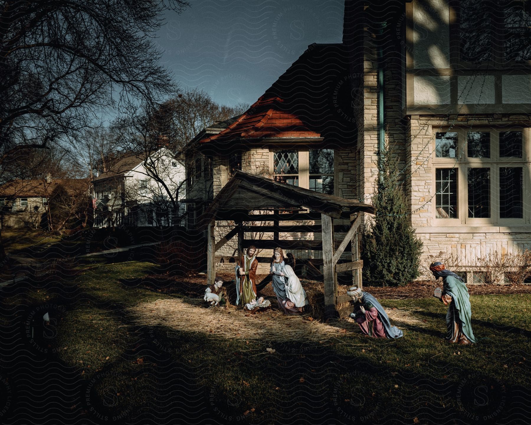 Several religious dolls are in front of a house 3e below a small wooden hut