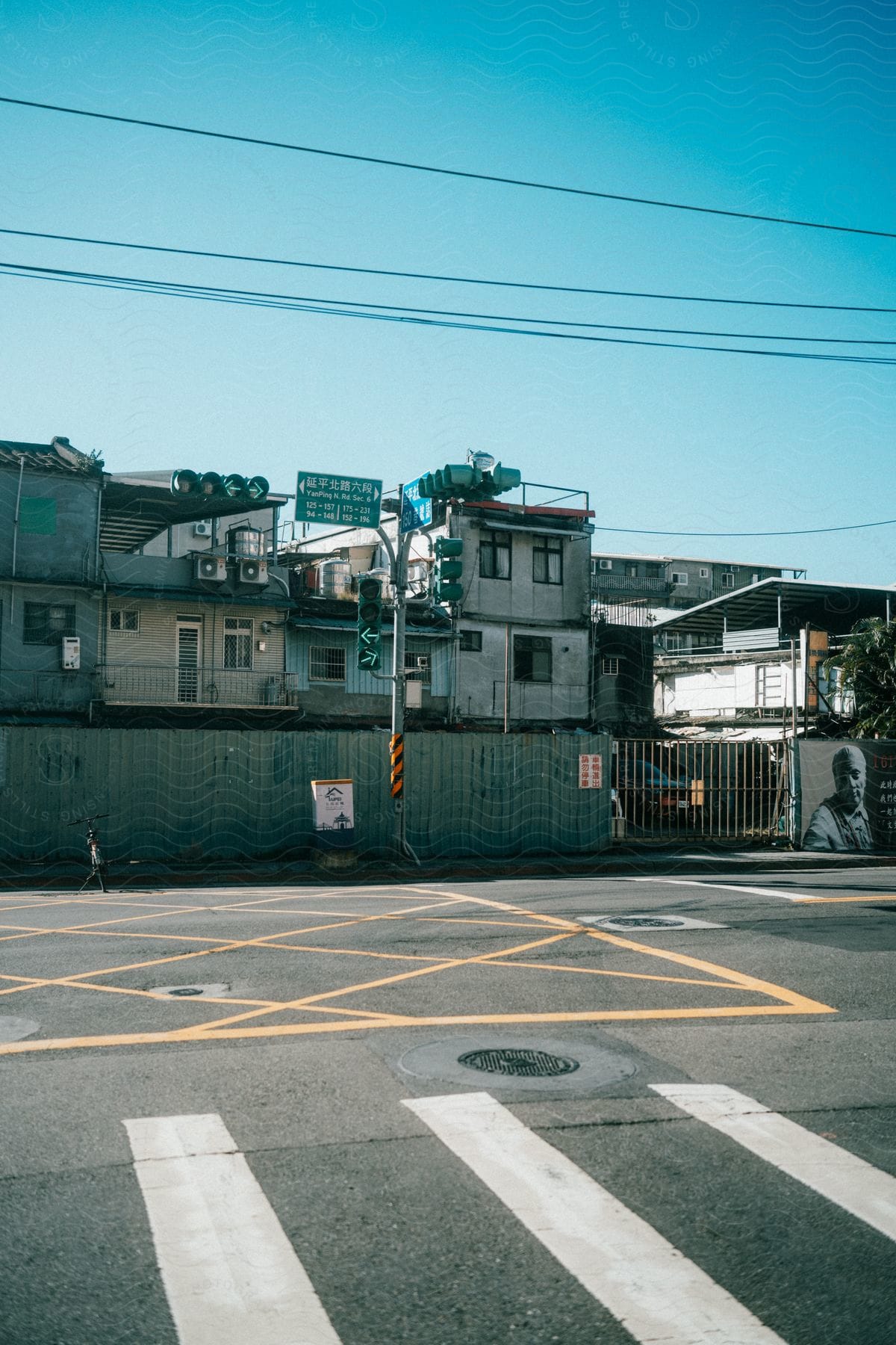 Signs and traffic lights along a road in front of apartments