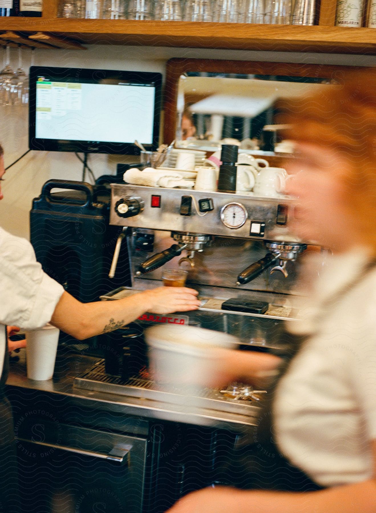 Blurry image of two people working at a coffee shop.