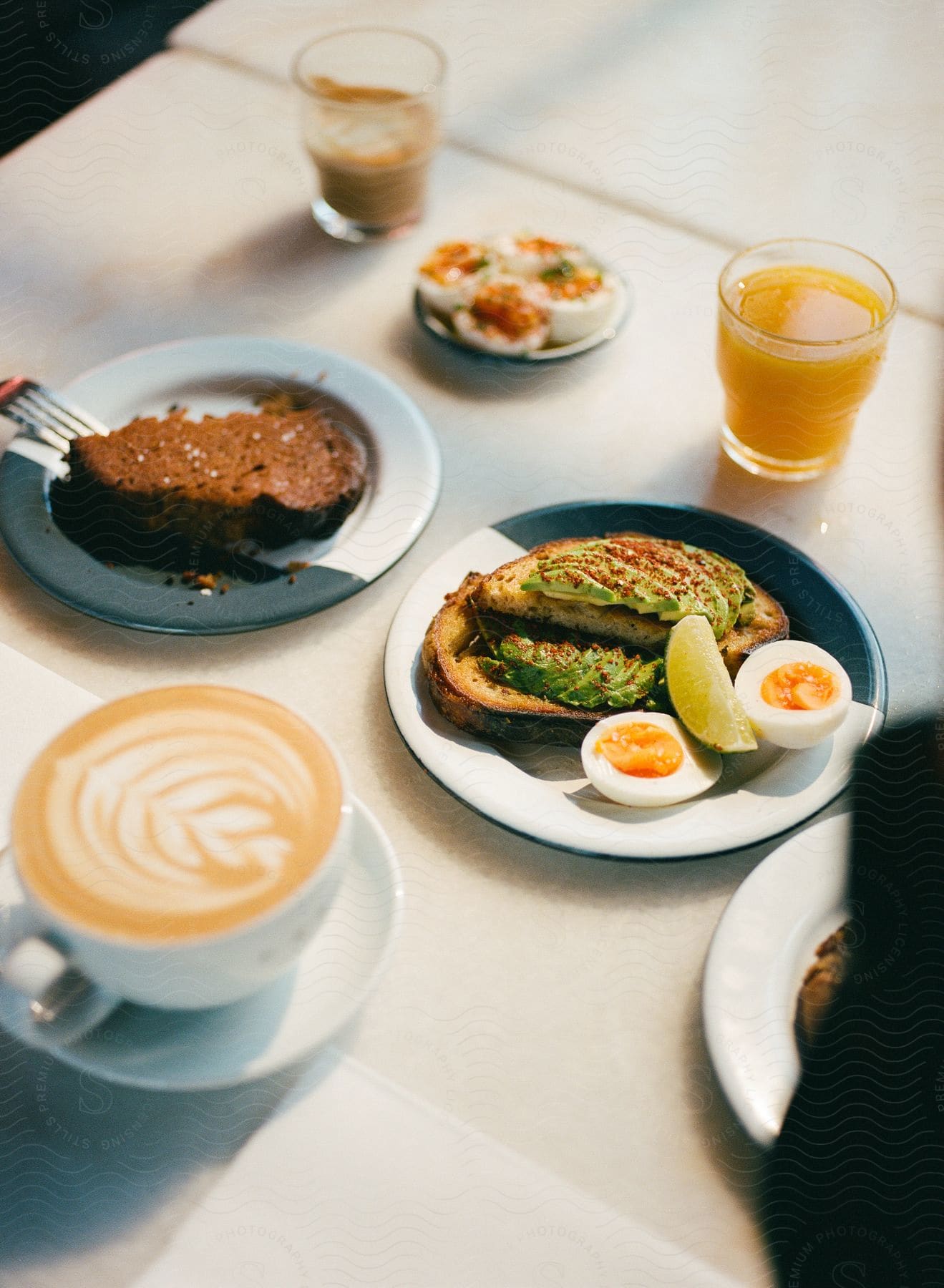 Breakfast on a table with juice and coffee and desert