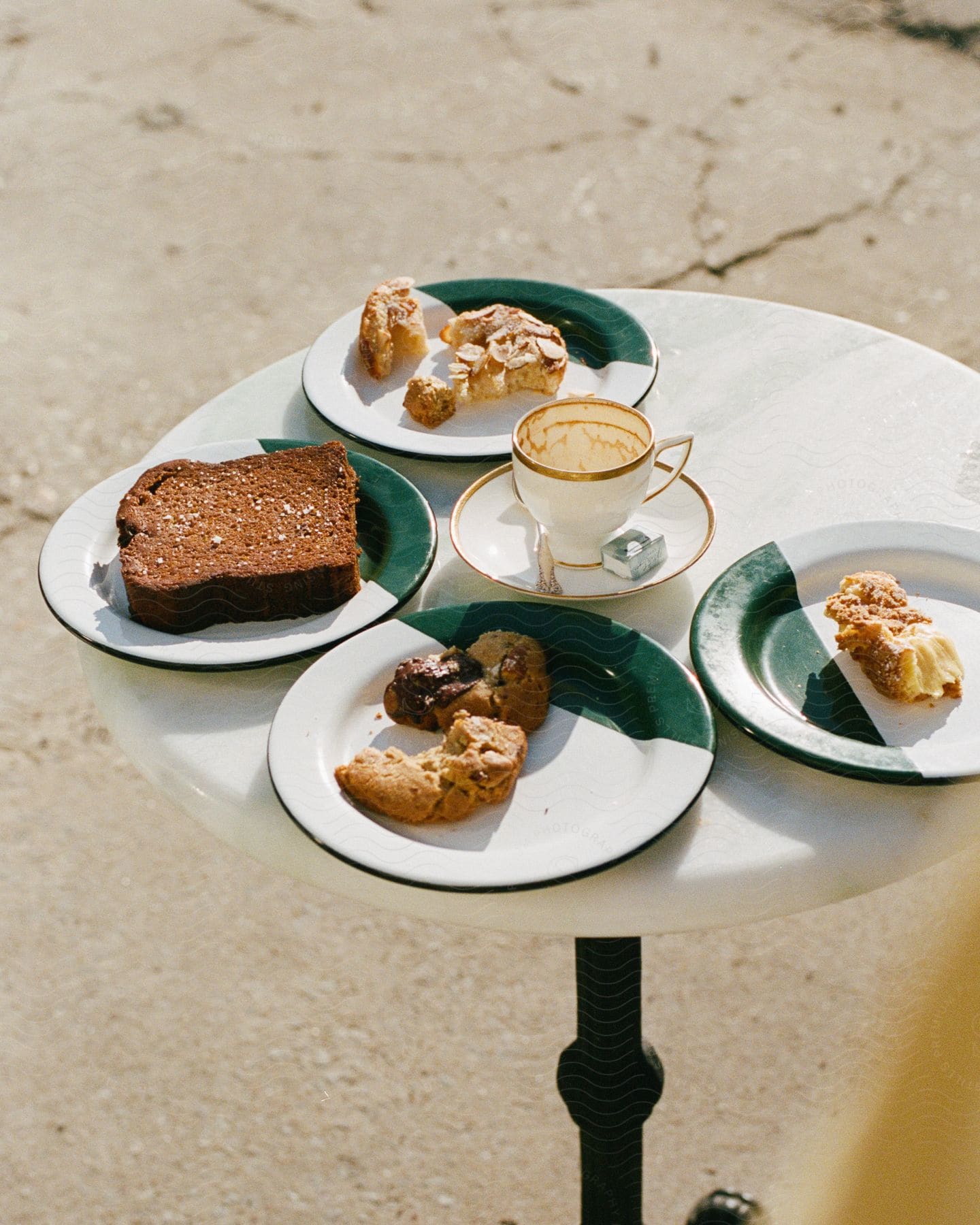 A meal sitting on plates on a table outdoors at a restaurant.