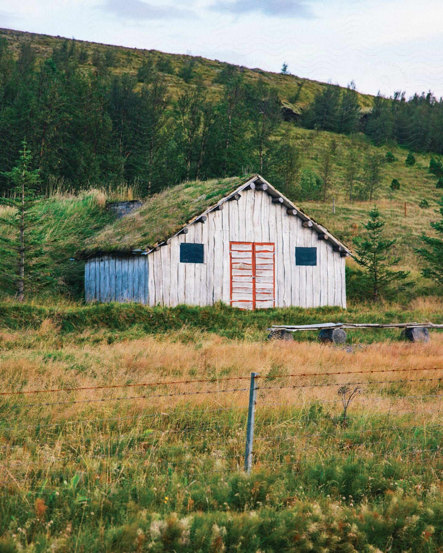 A small farm on a hill in the countryside.