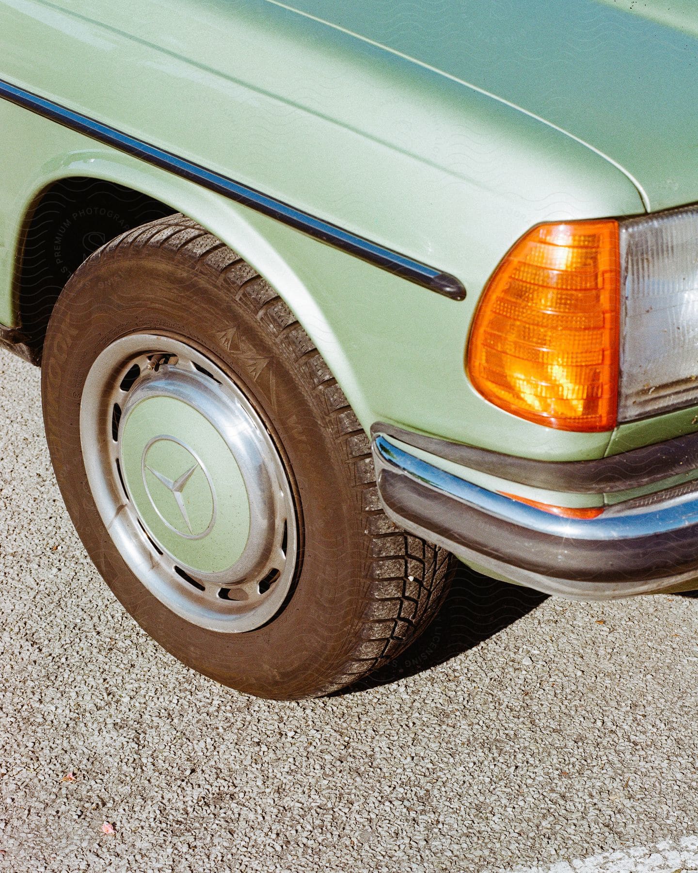 Headlight and front wheel of a car.