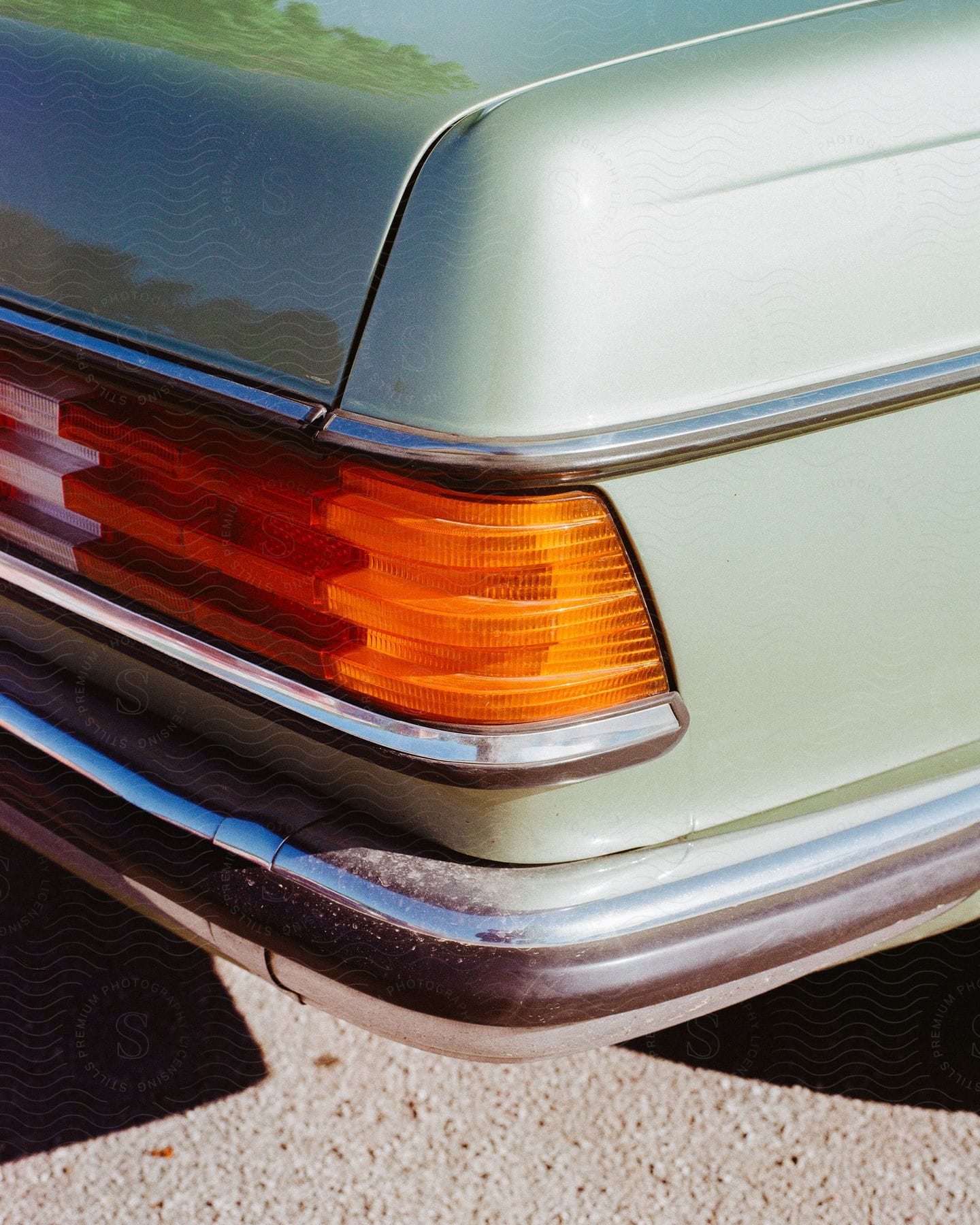 Stock photo of the taillight of an old car outdoors.