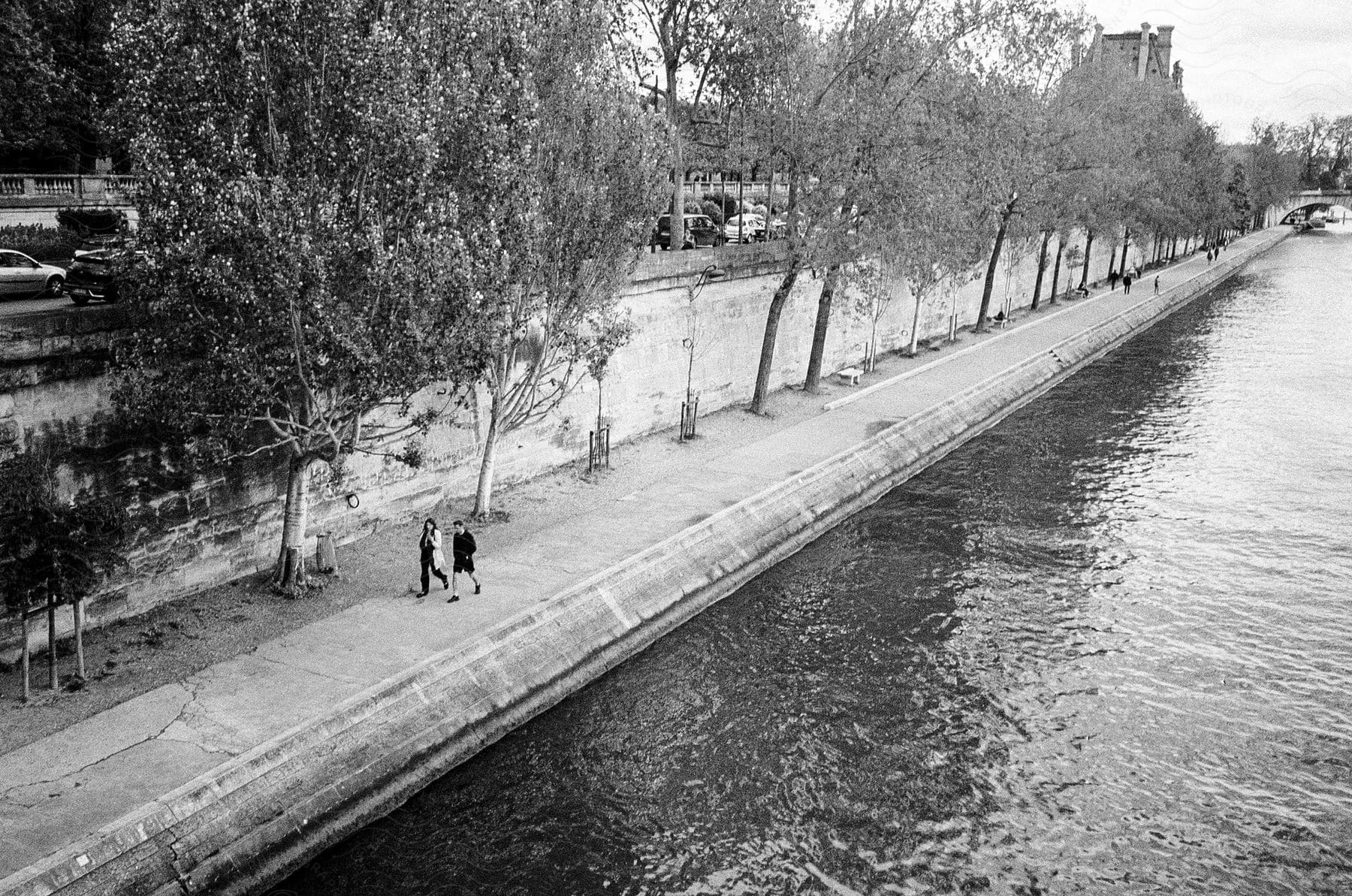 People walking along the Seine river in Paris