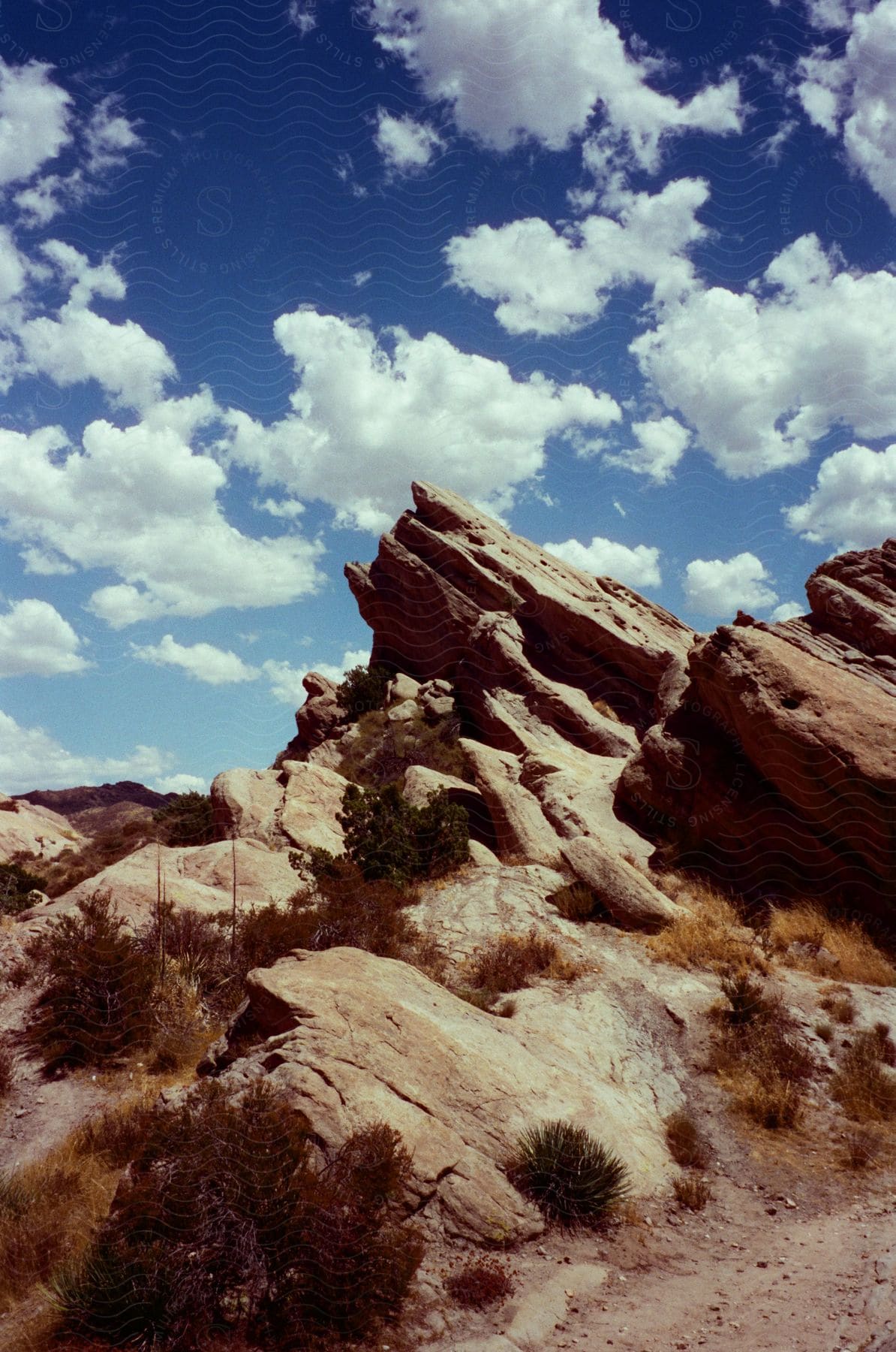 White fluffy clouds in the bright blue sky above the Vasquez Rocks