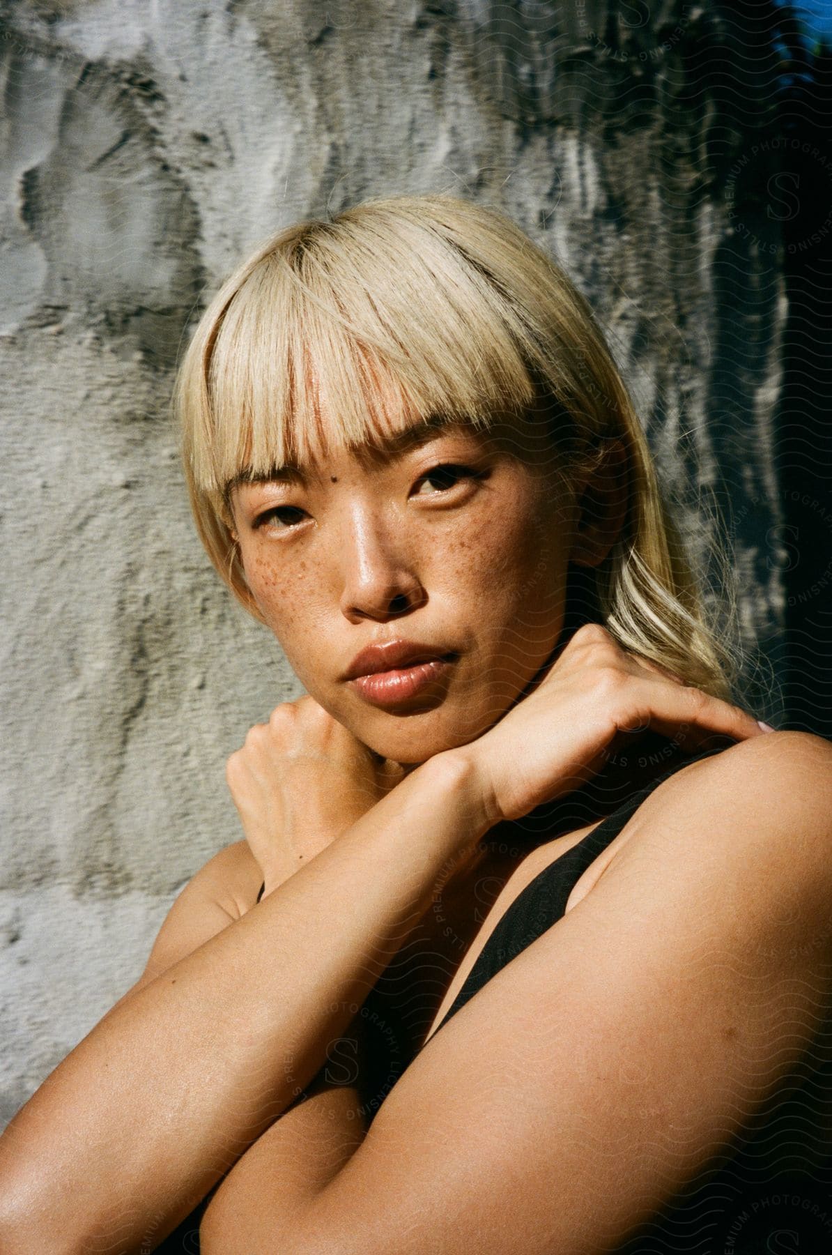 A young Asian woman with freckles on her face.