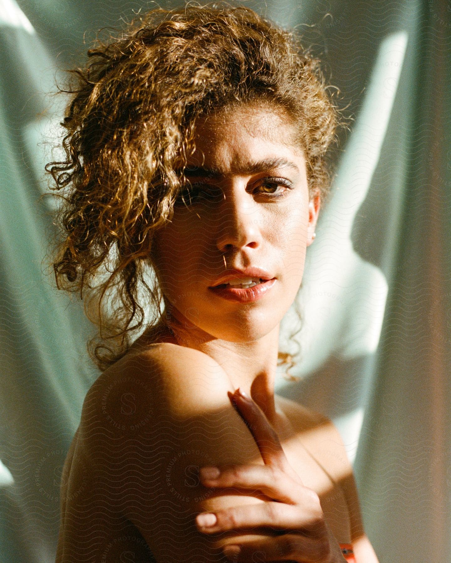 Portrait of a beautiful young woman with curly hair.