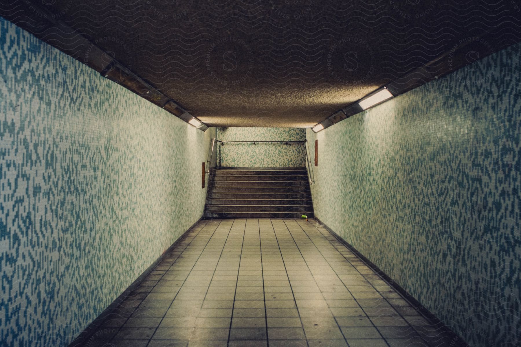 an underground walkway leading to a staircase