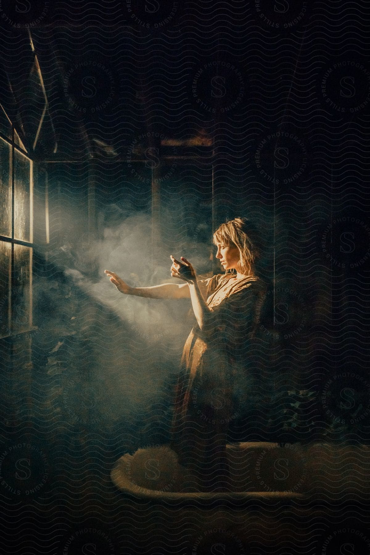 Model standing in a vintage bathtub in a dark setting with a reflection of light underneath her.