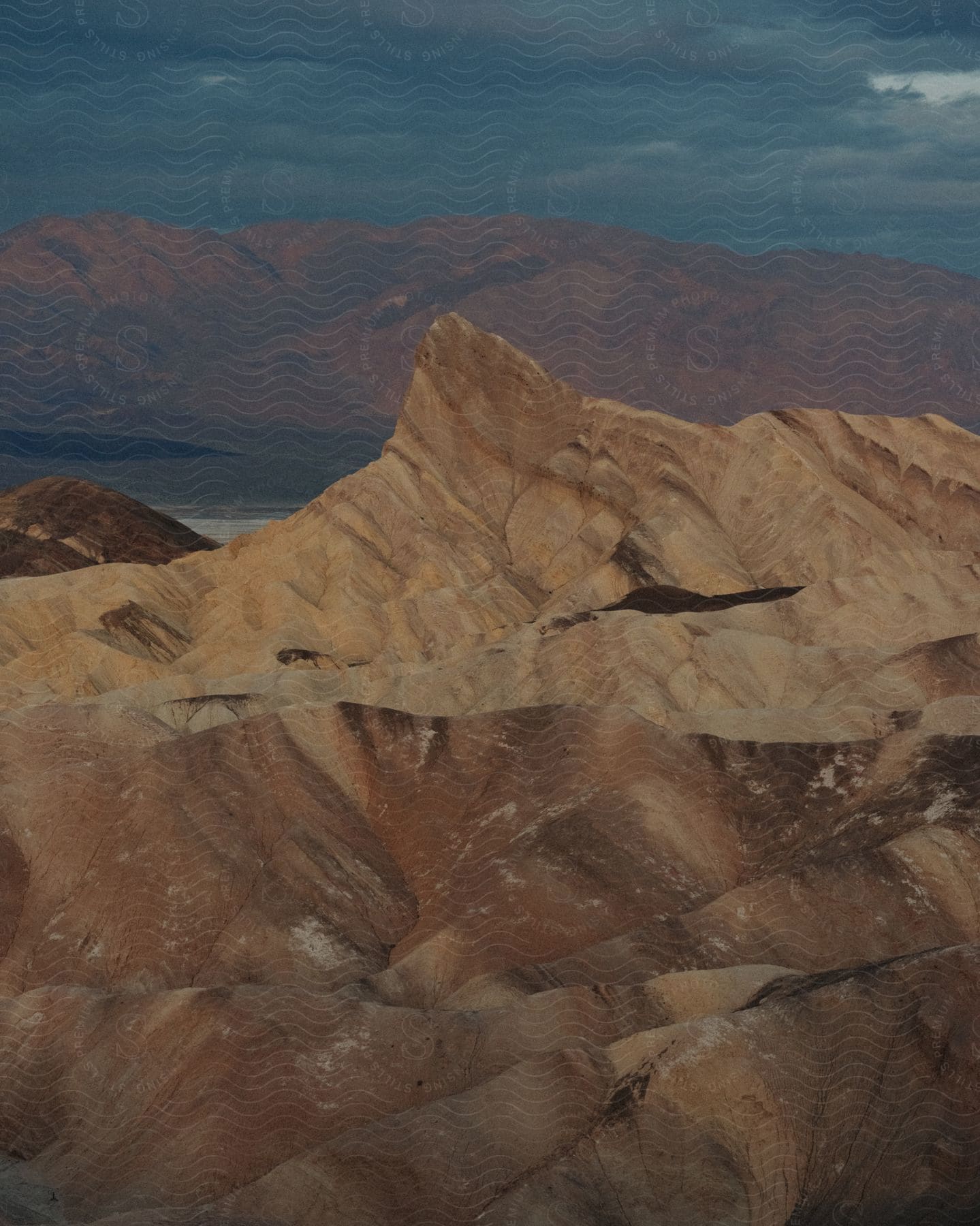 Rough terrain mountains and slopes with peaks high in a dark cloudy sky