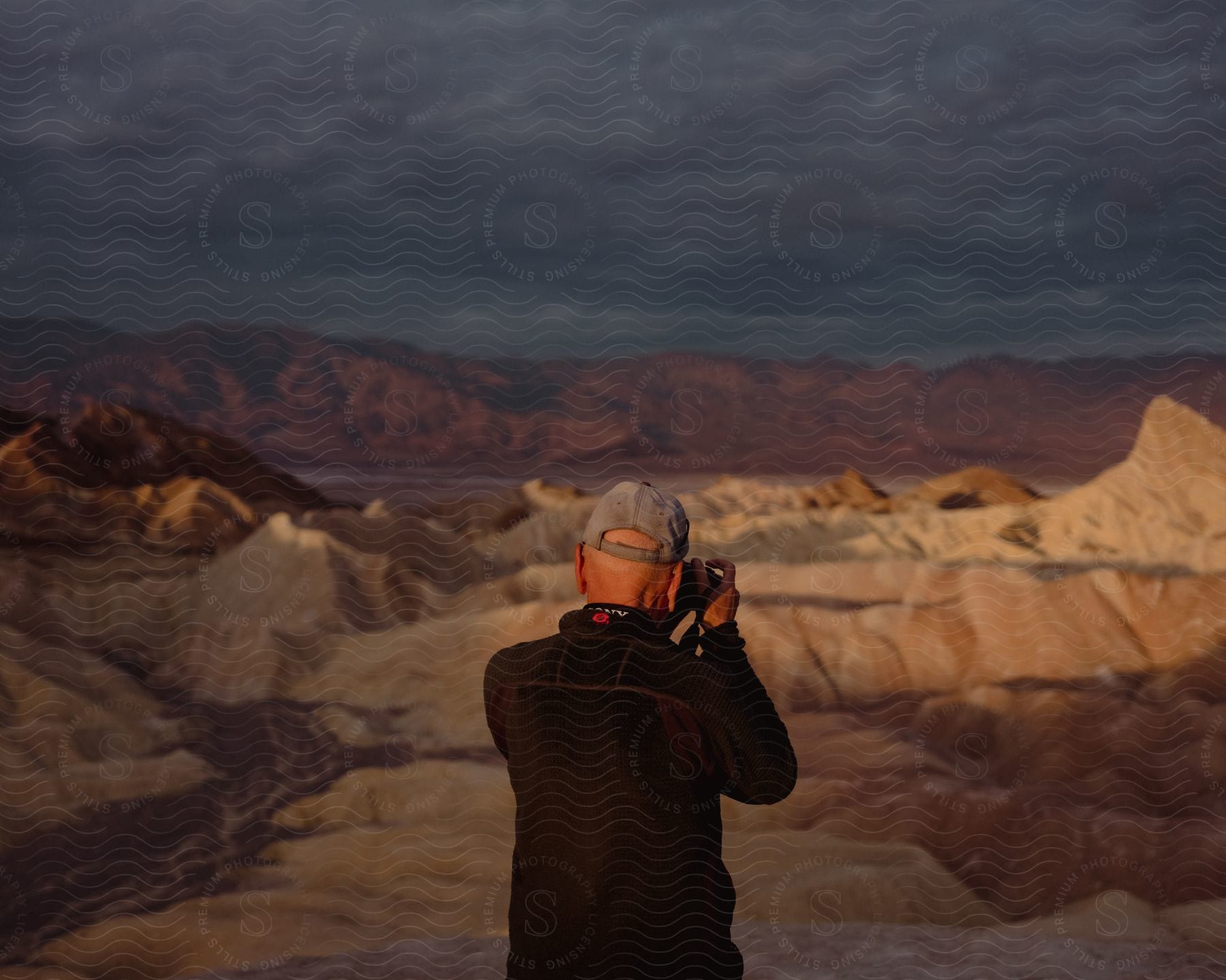 A photographer photographing the desert landscape of the canyons during sunset.
