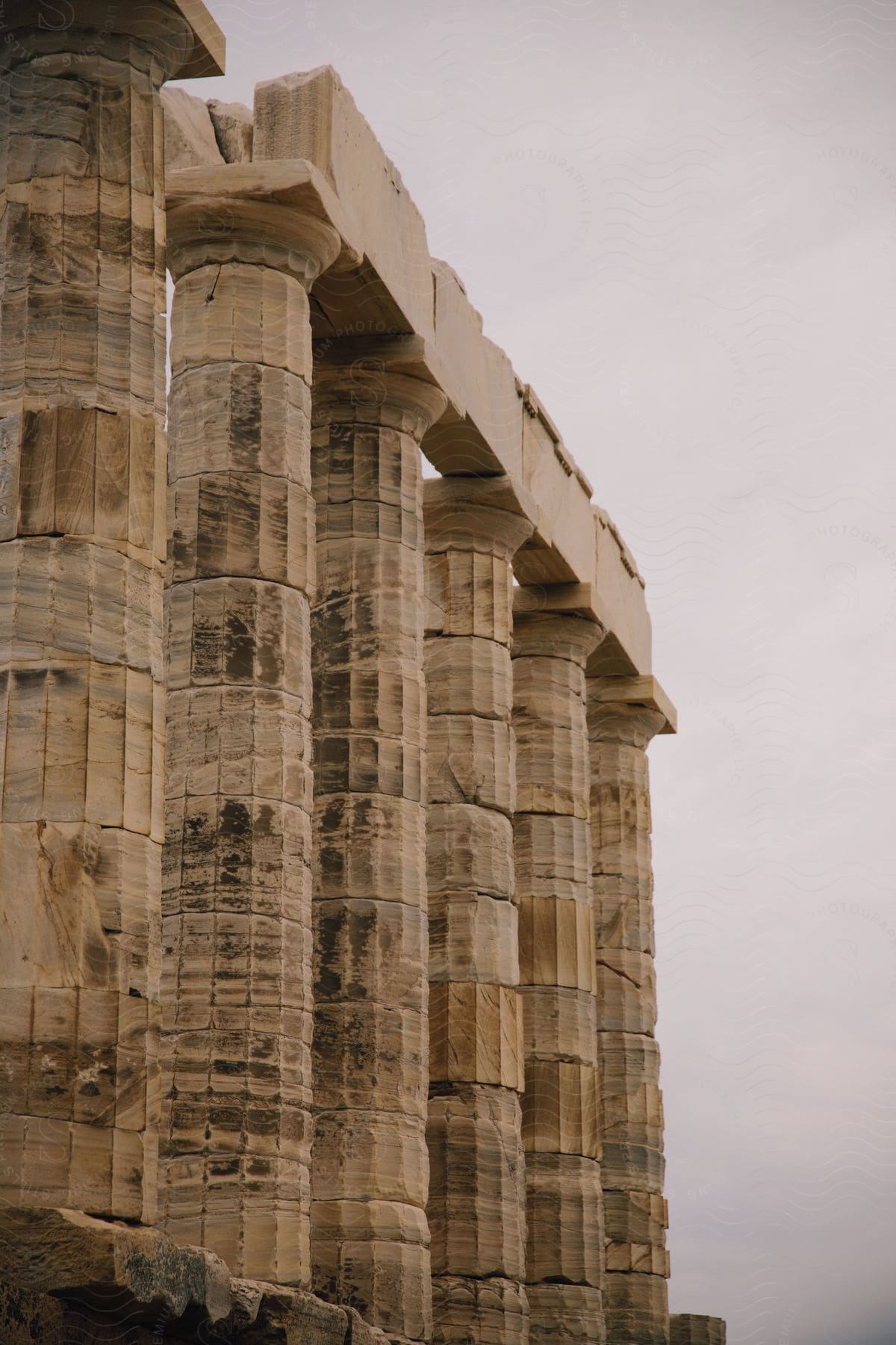 Columns of the Temple of Poseidon on a cloudy day.