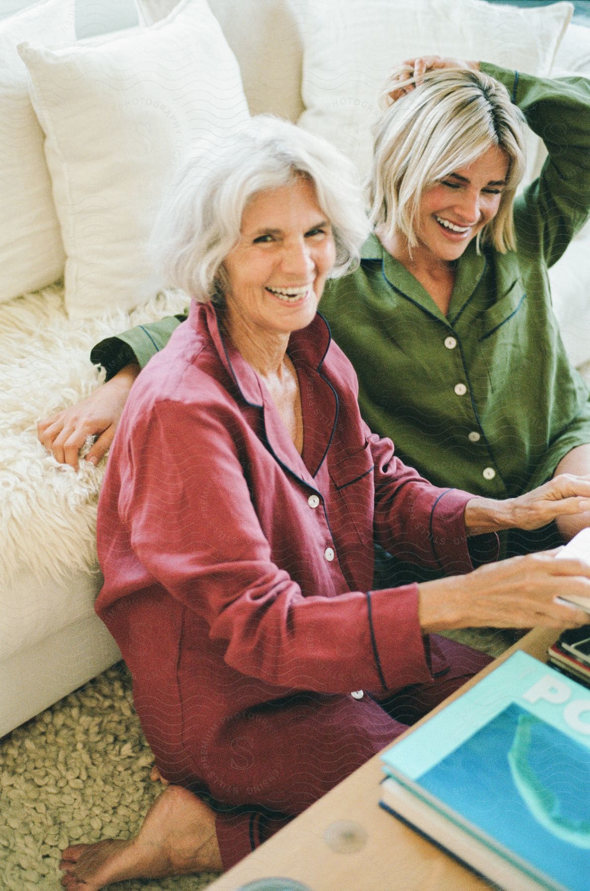 An image of a blonde mother and daughter laughing in the sitting room