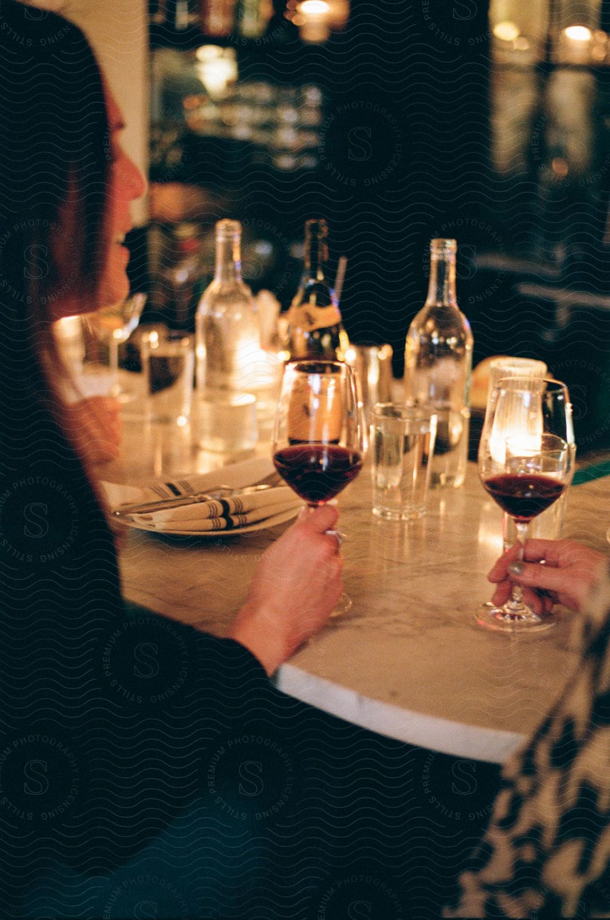 A person drinking wine in a fancy restaurant.