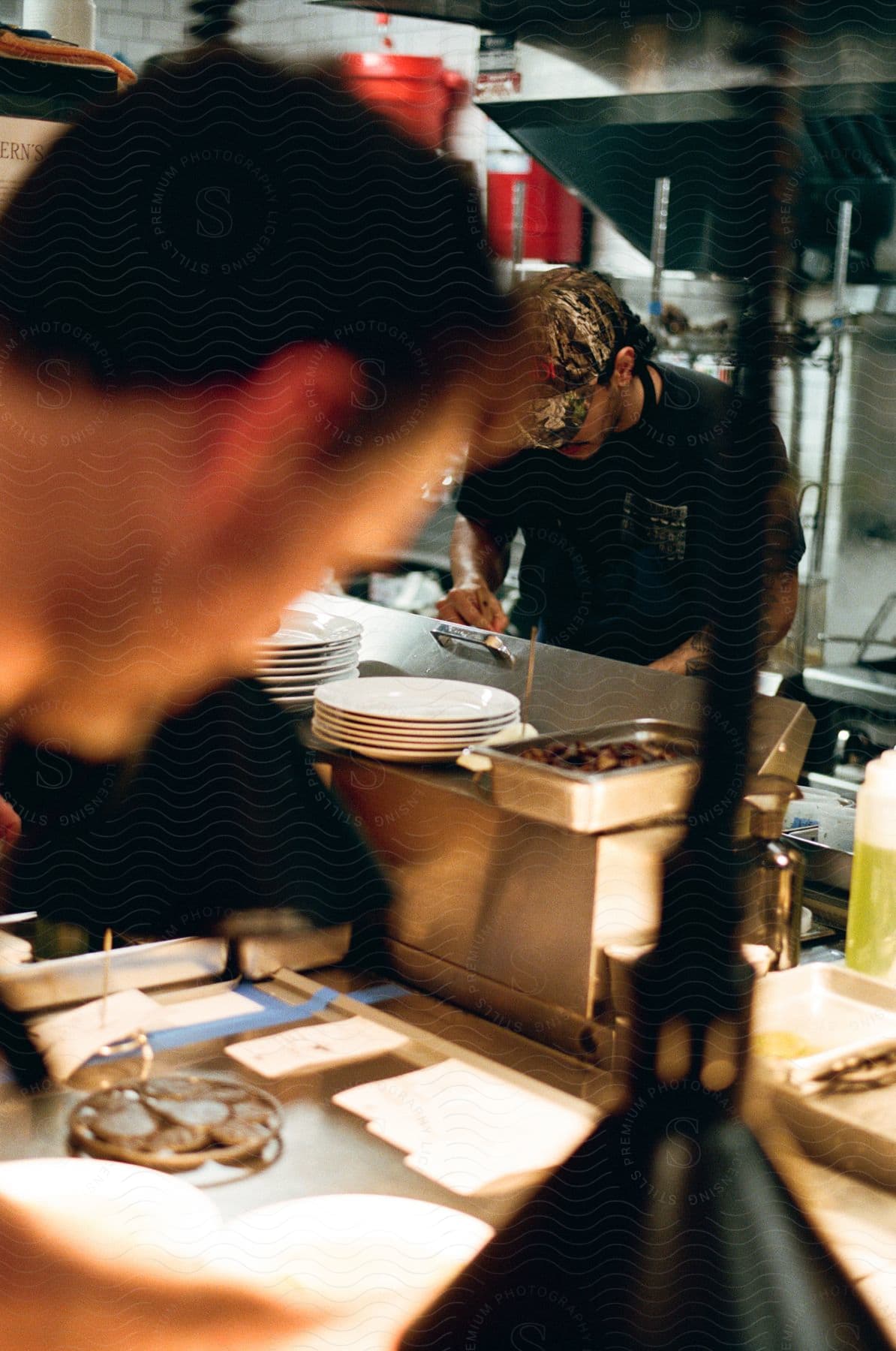 Two men making food in a restaurant