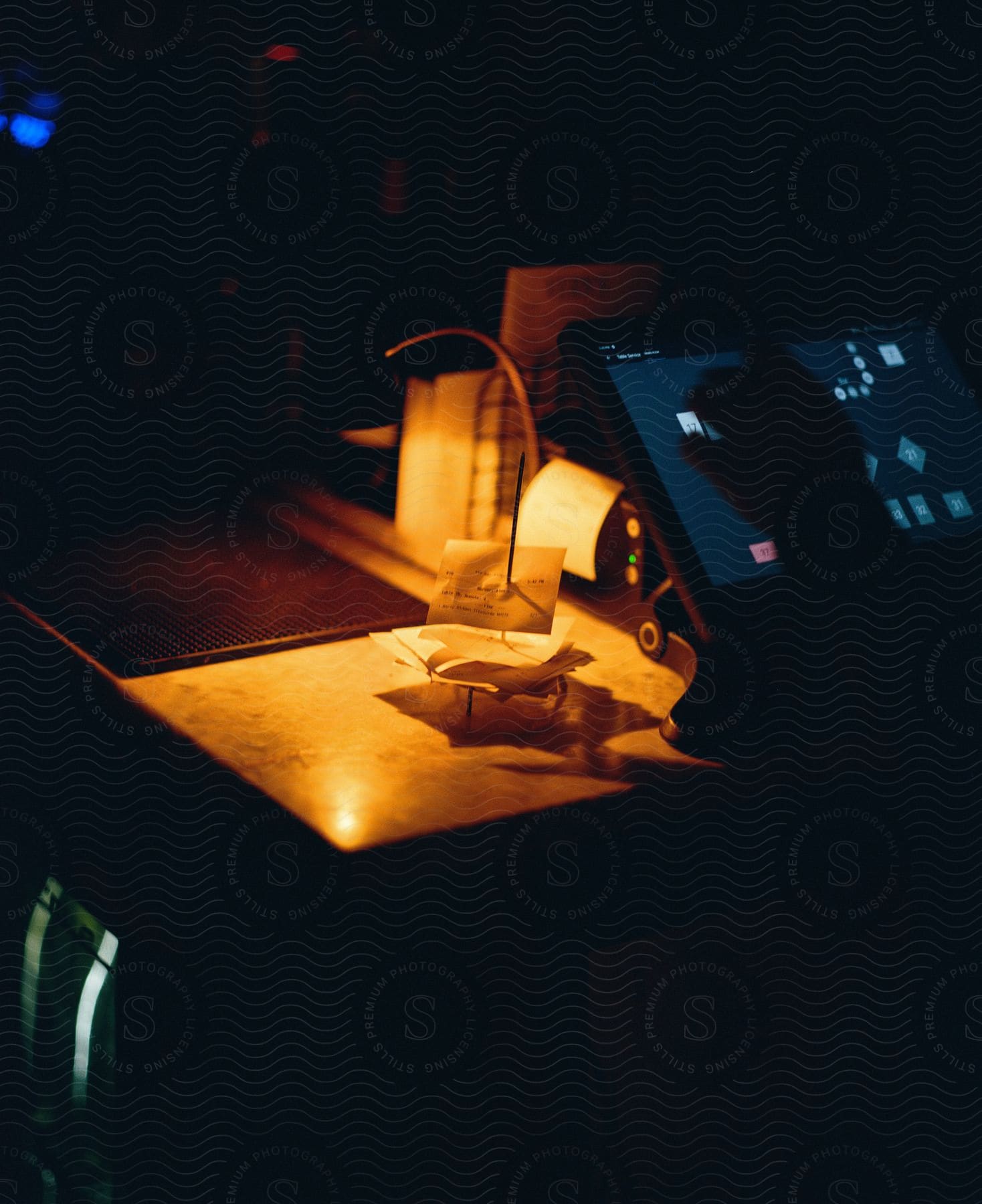 a computer screen in a dark room with a warm light