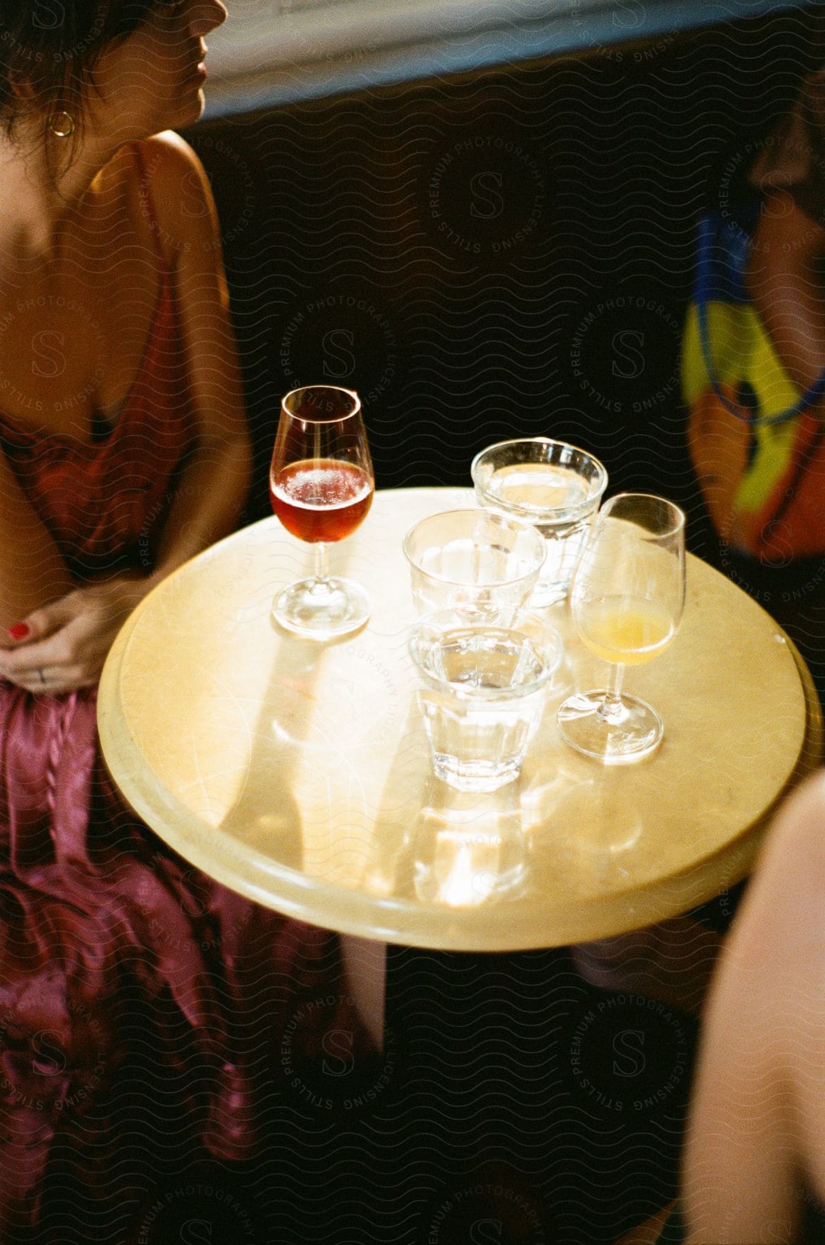 Women are sitting at a table with glasses of wine