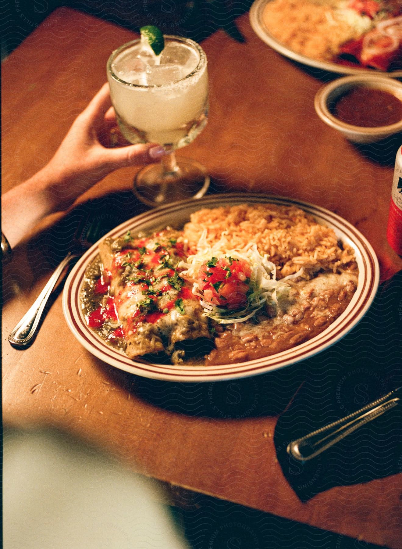 A rice based Indian dish, accompanied by a mojito.