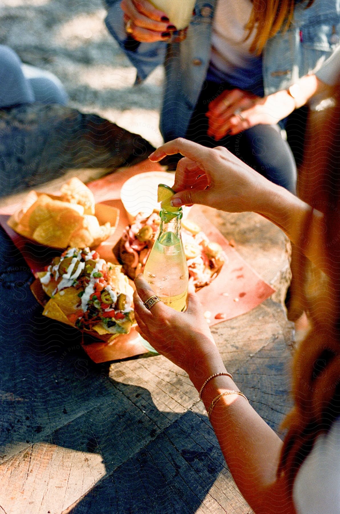 Two people sitting outside eating some nachos