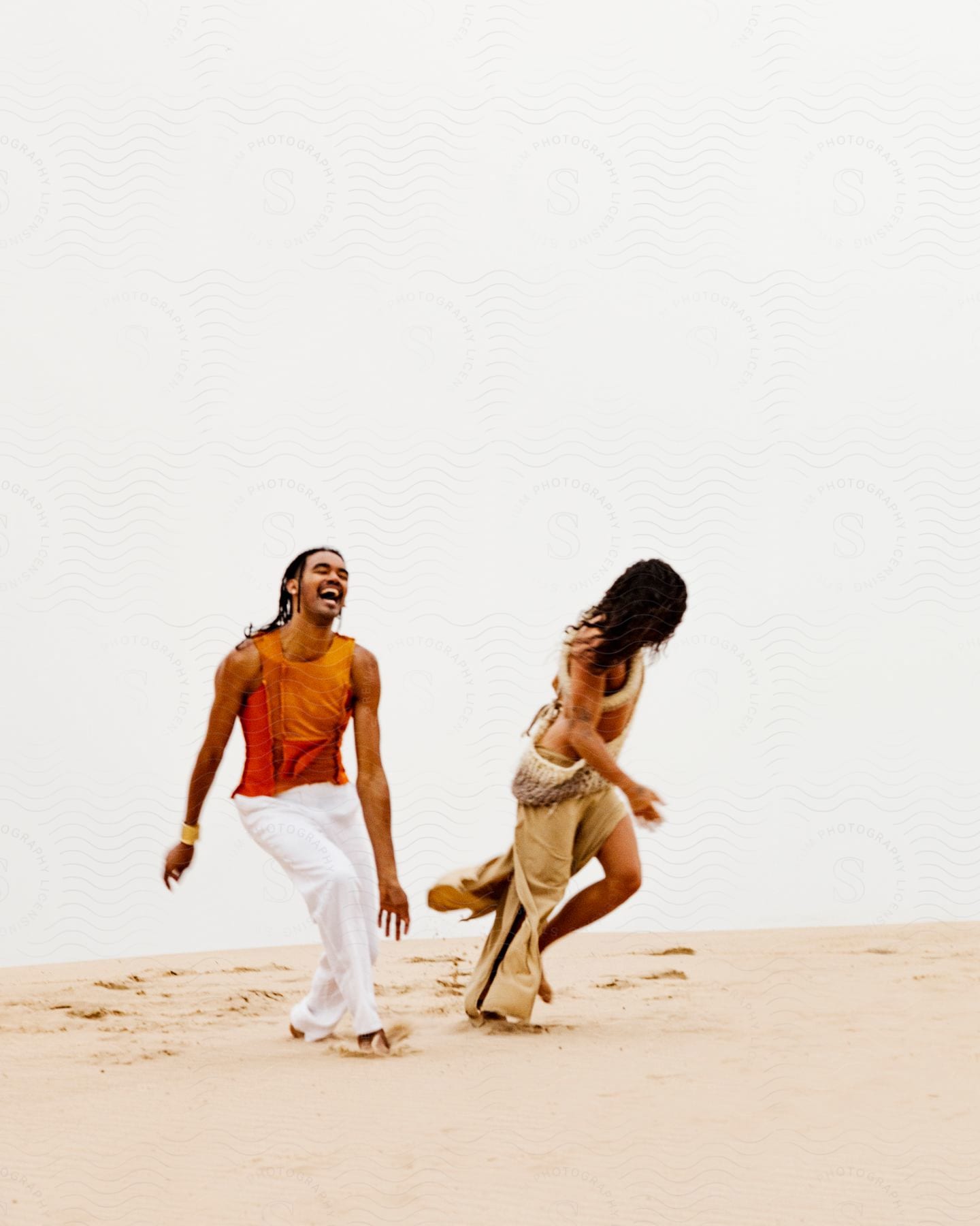 A man and a lady playing on the beach