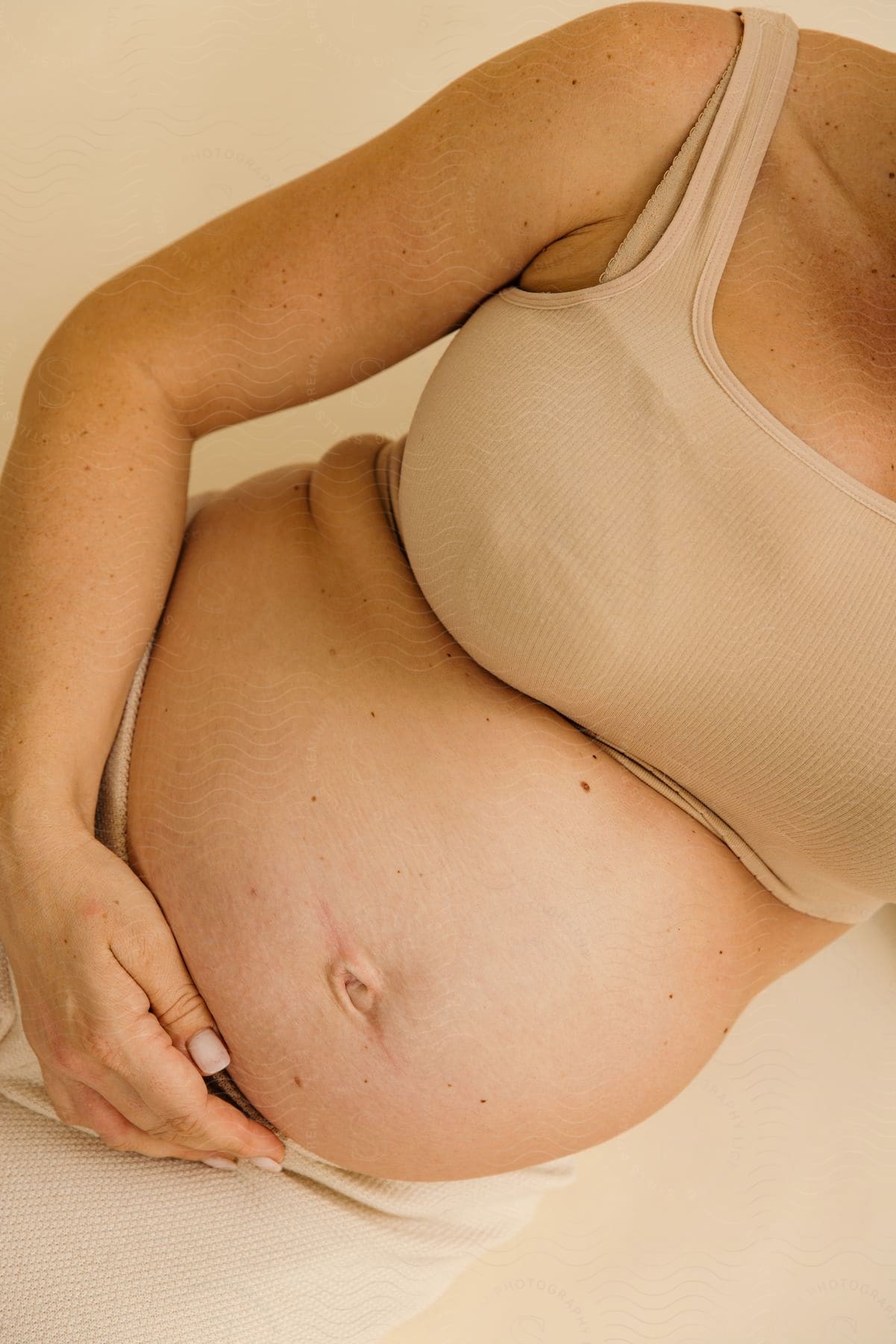 A portrait of a woman laying down pregnant