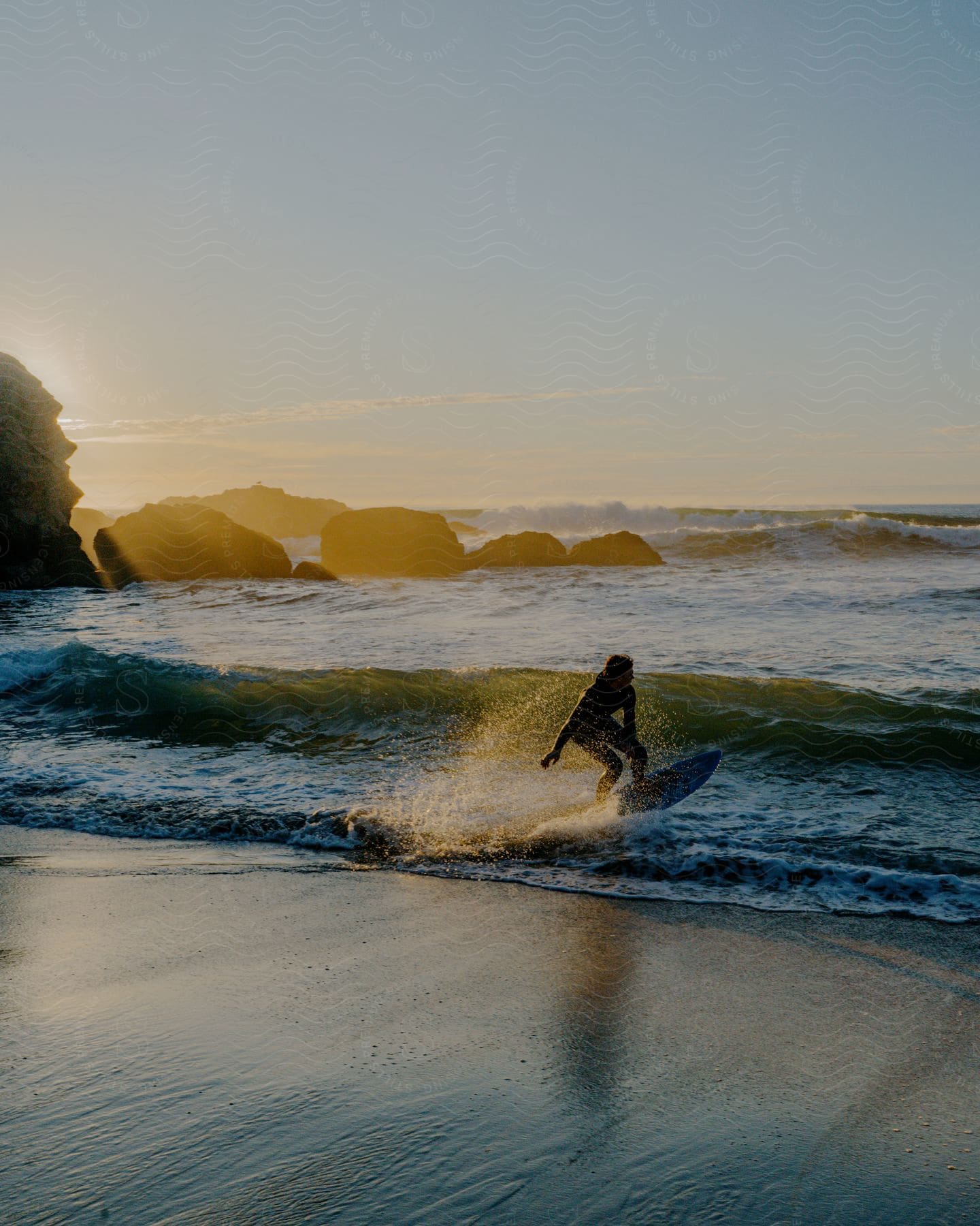 A woman surfing breaking waves.