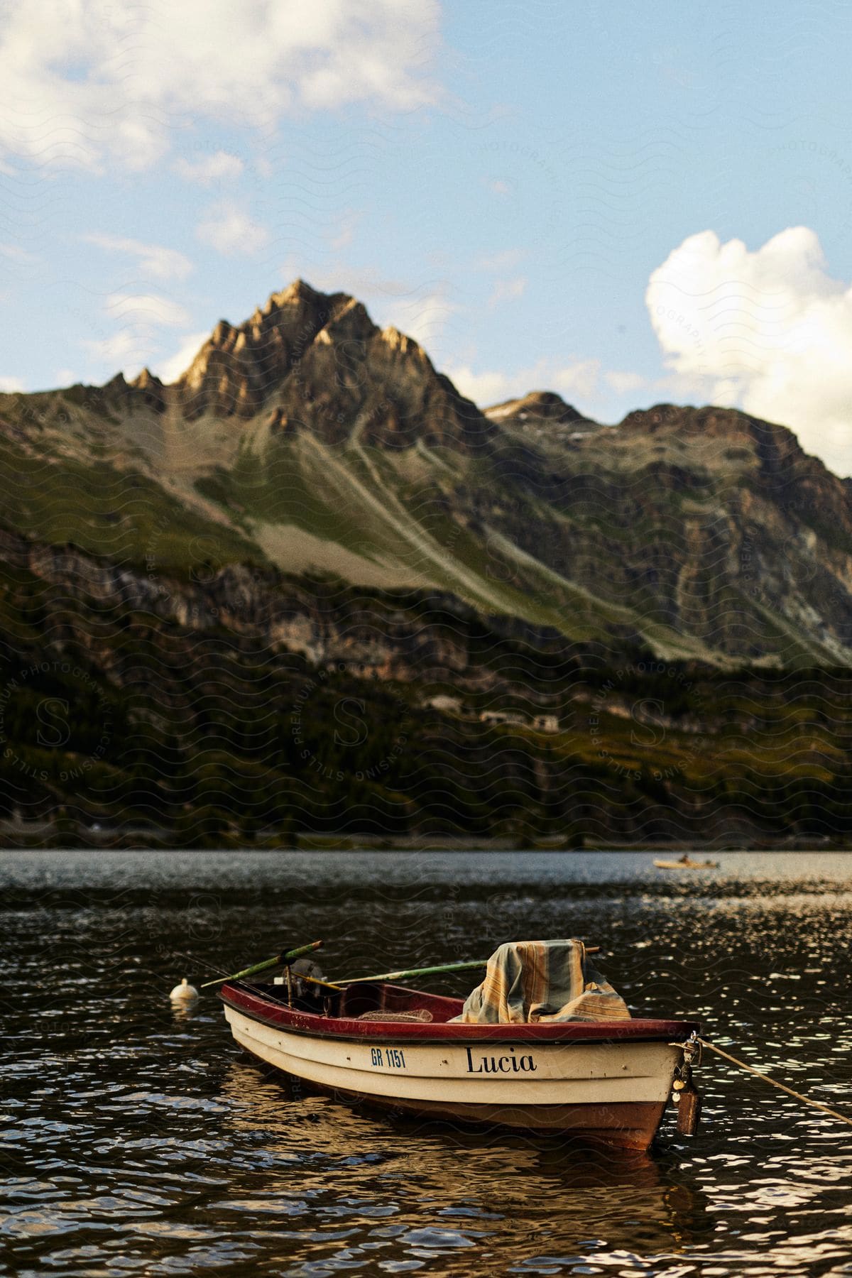 Canoe on a lake with a view of a mountain range.