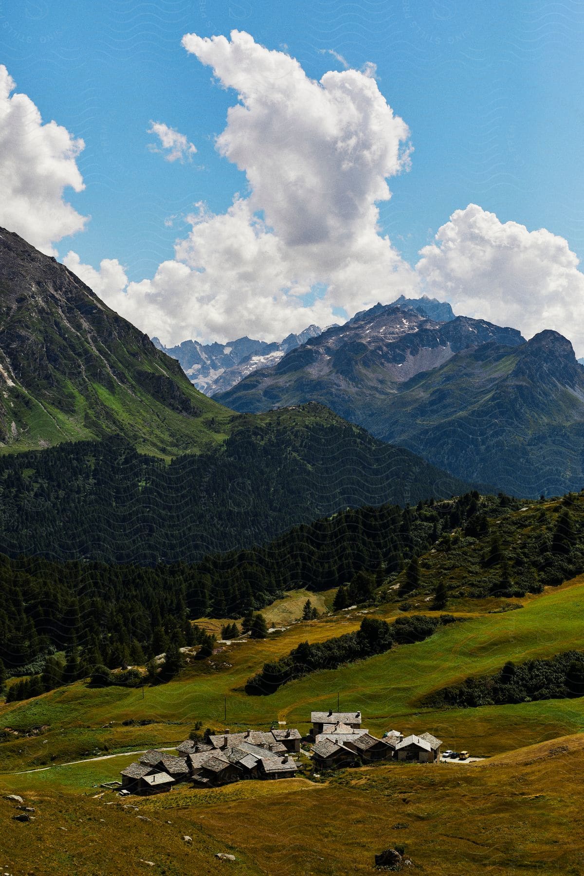 Aerial of a small village in the mountains on a sunny day.