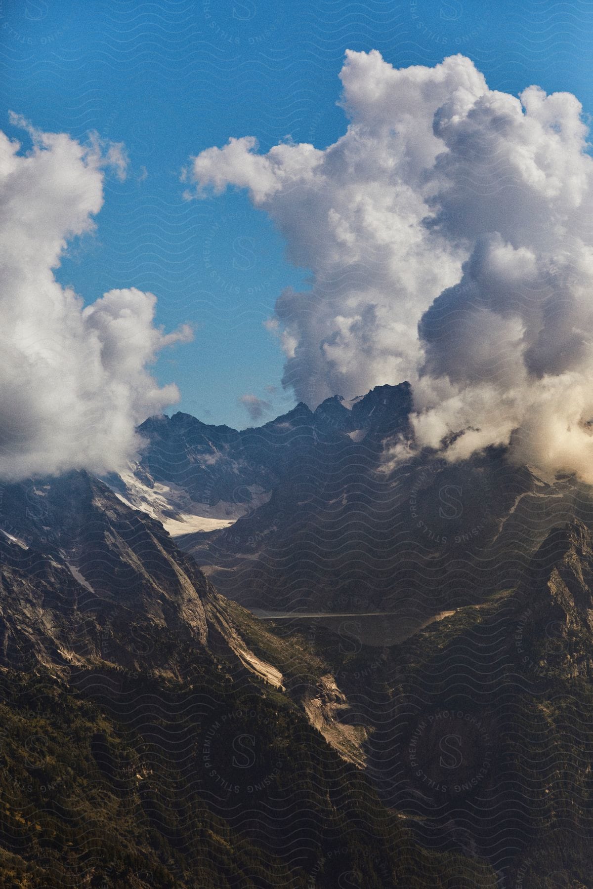 Stock photo of the sun shines on the mountains high in the clouds