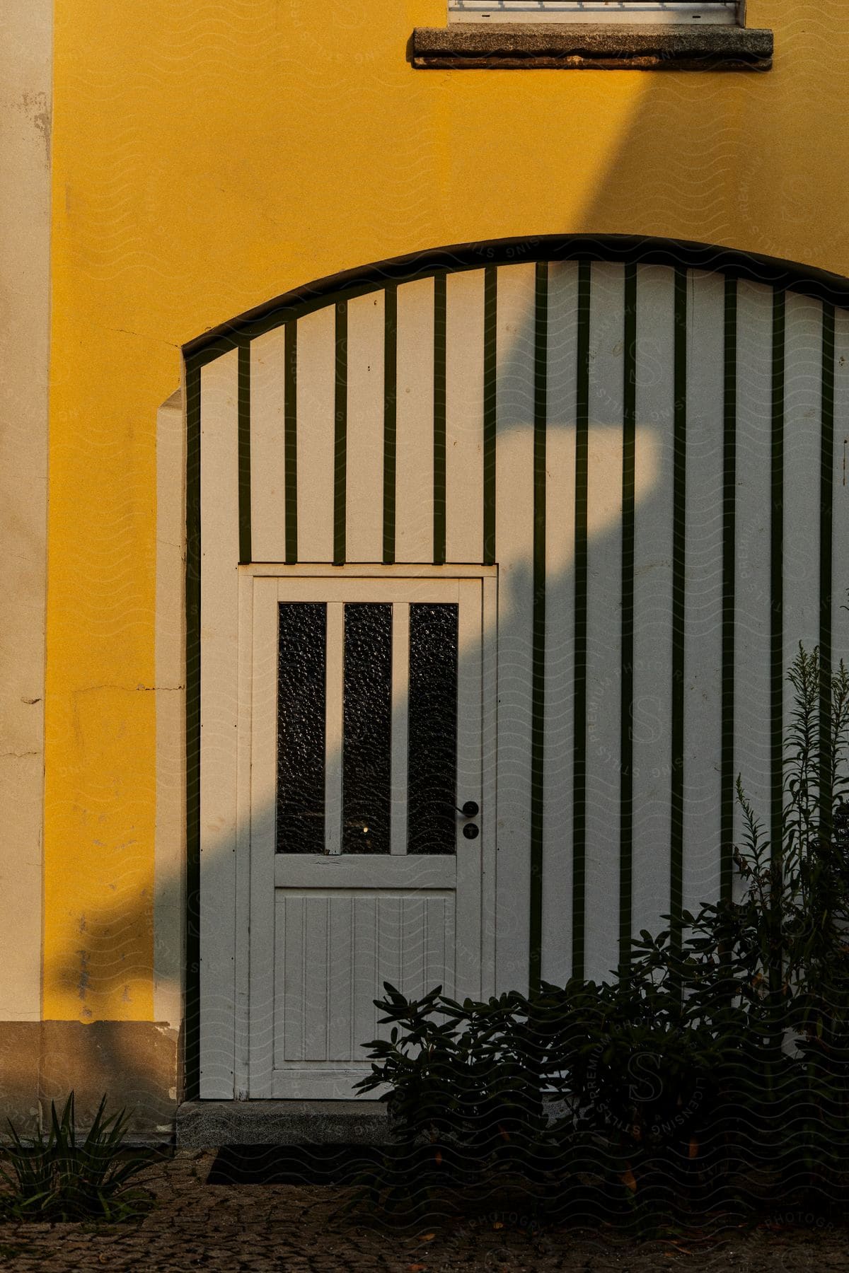 Exterior architecture of the facade of a house with a white door and yellow wall