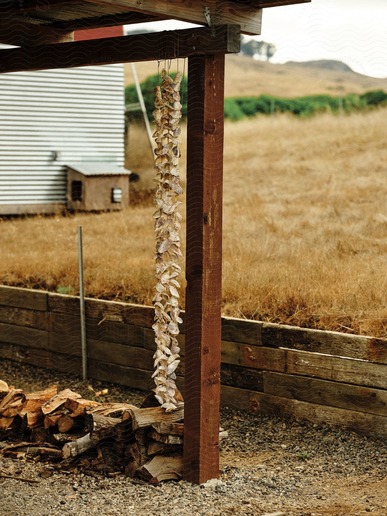 A porch with a roof and cut wood.