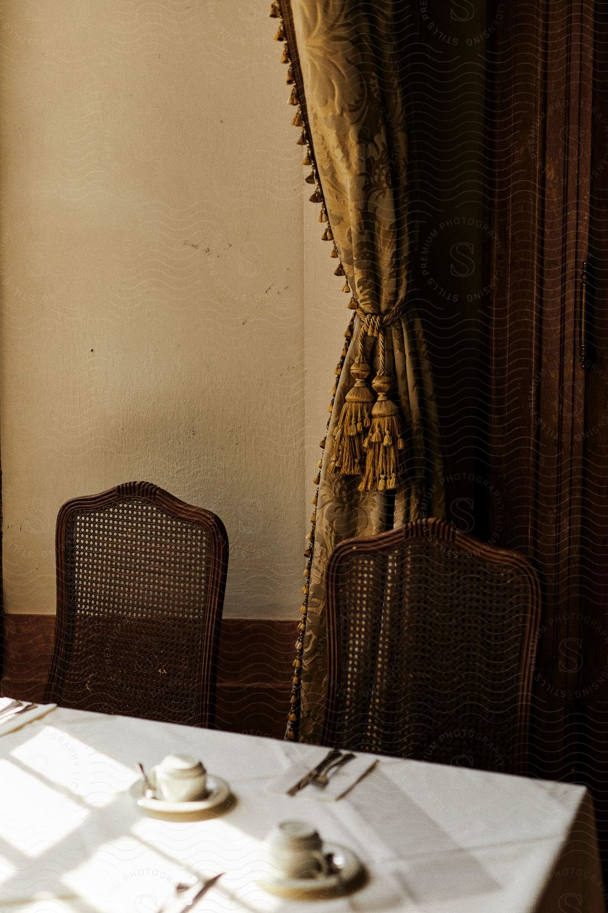 a dining room with chairs and curtain