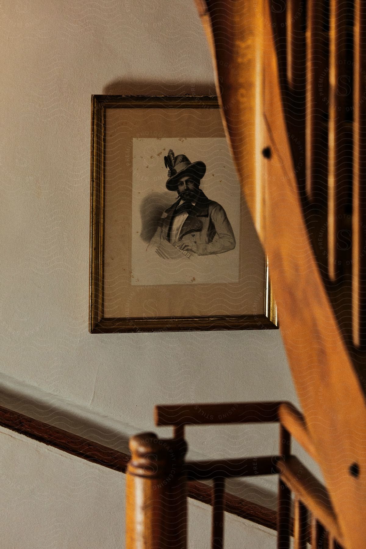 An old portrait hangs on the wall of a house.