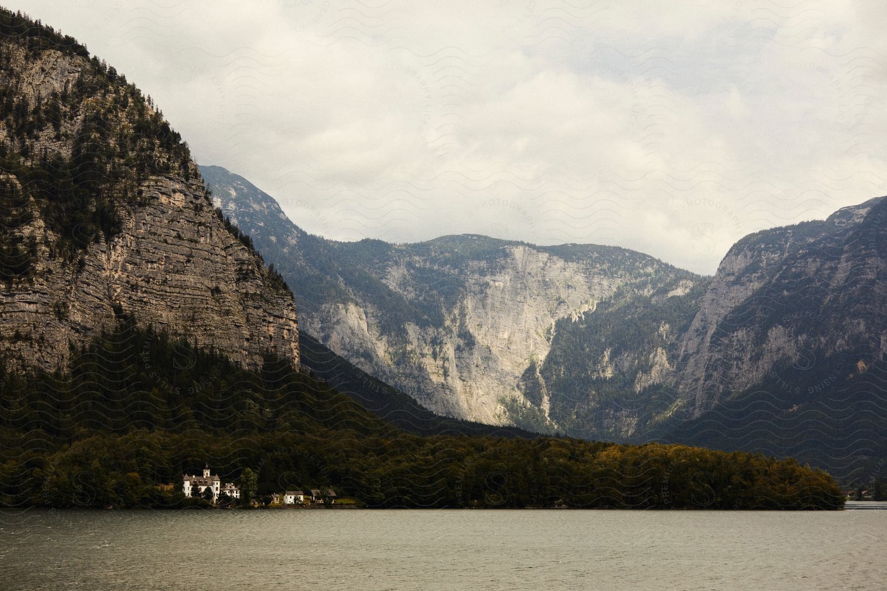 A small coastal town surrounded by forests and mountains.