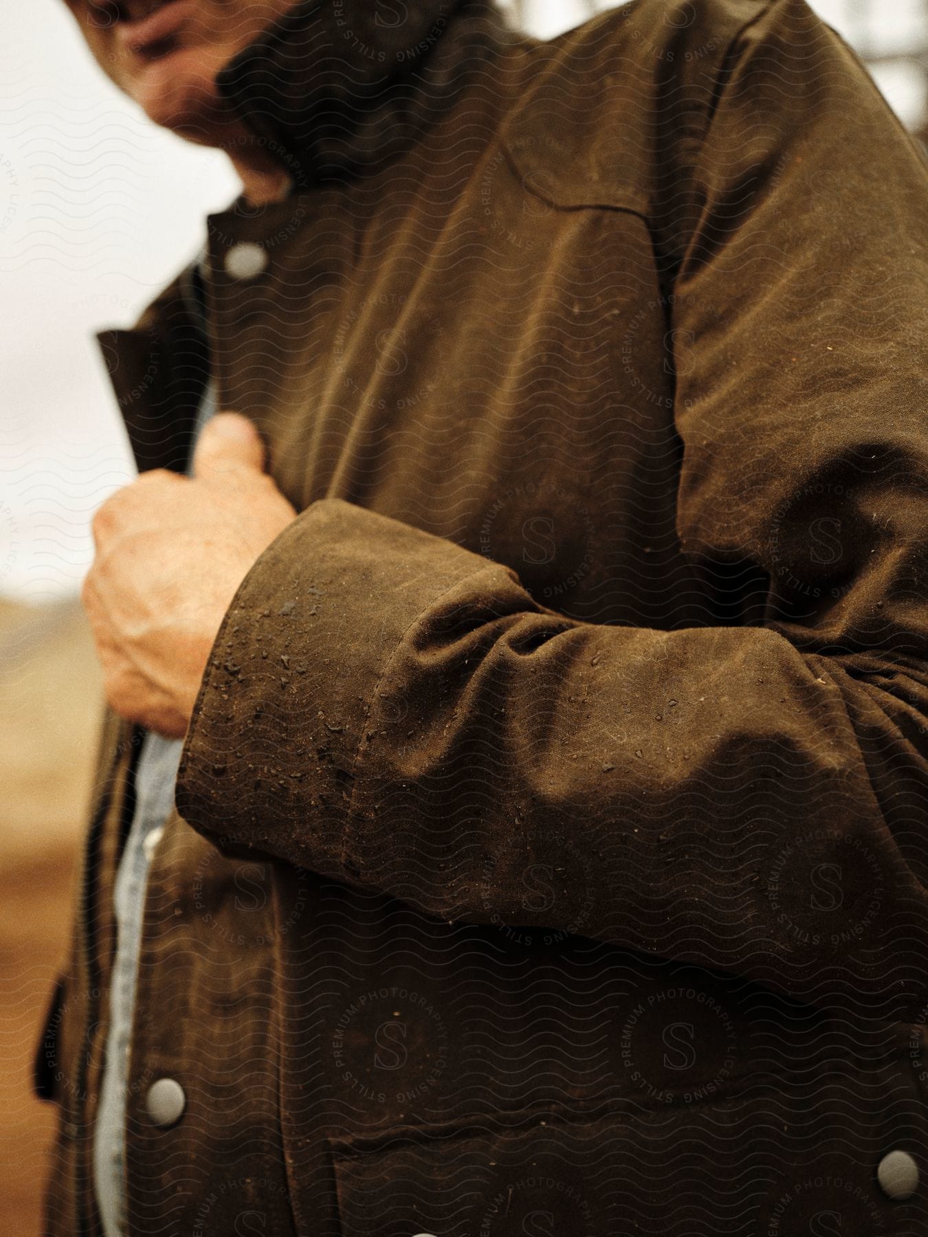 A man is wearing a brown jacket.