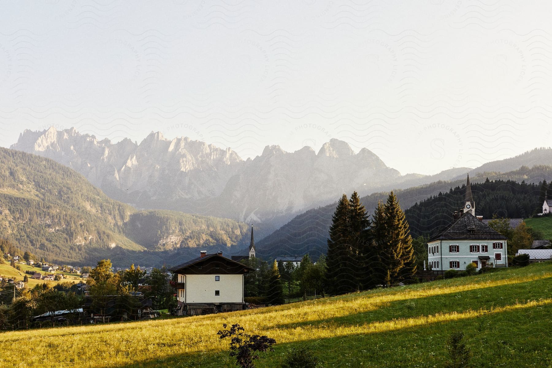 Panorama of a village with church houses amidst hills and mountains