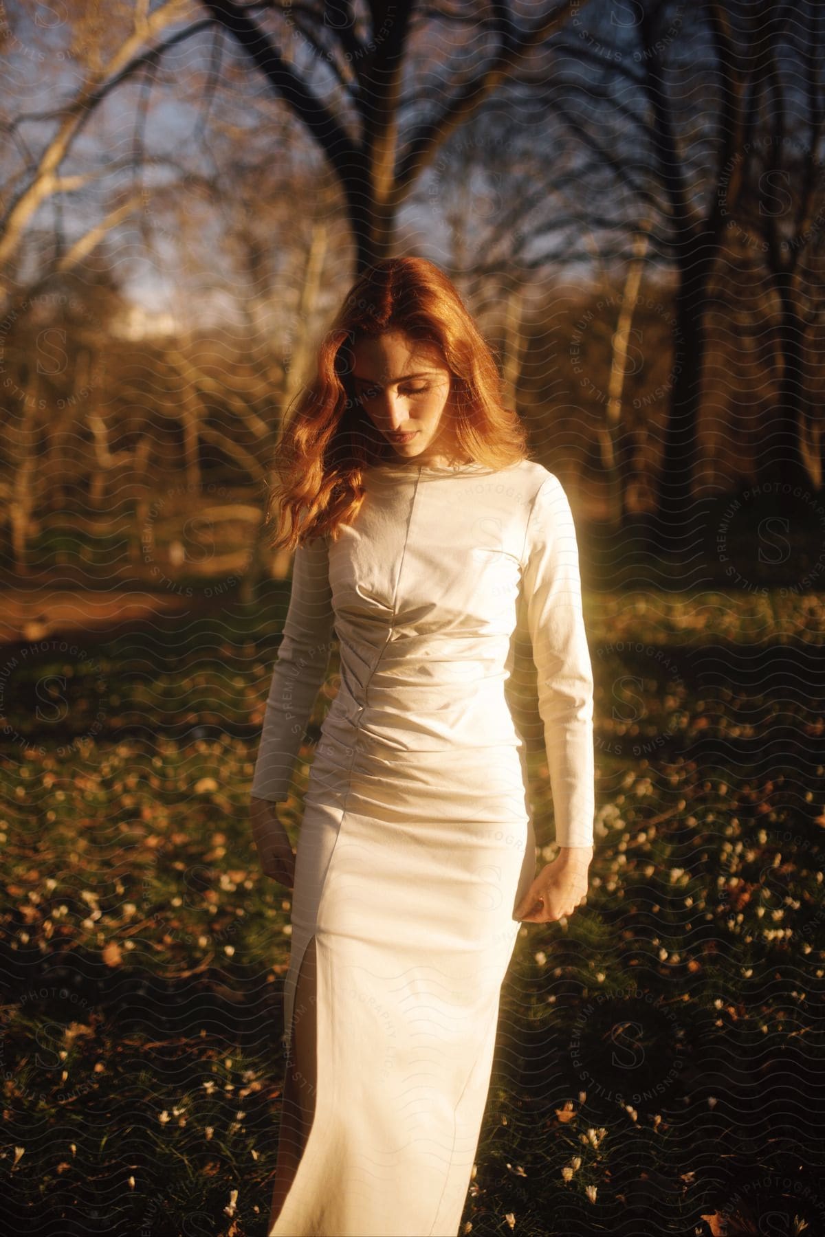 A woman standing outdoors in a dress modeling it.