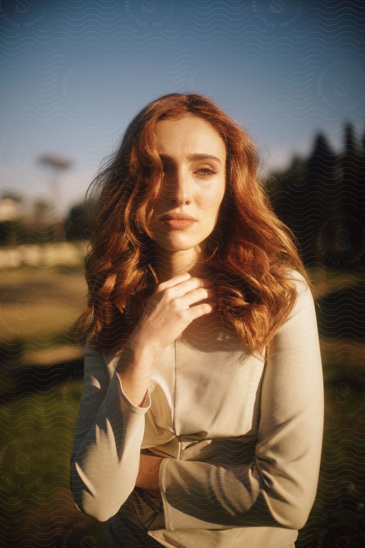 A blond lady posing for a portrait in a white shirt