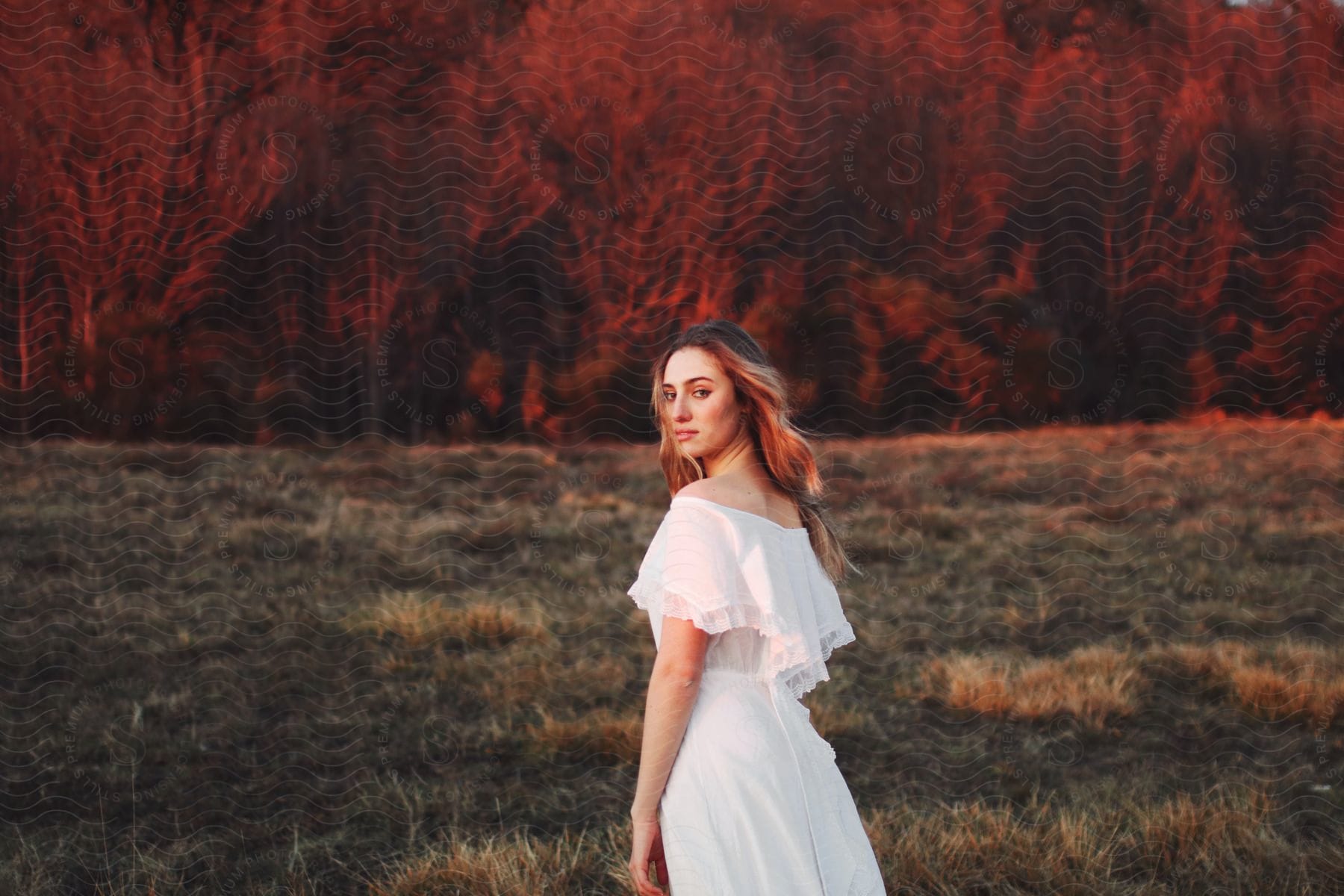 Woman in a field with a white dress.