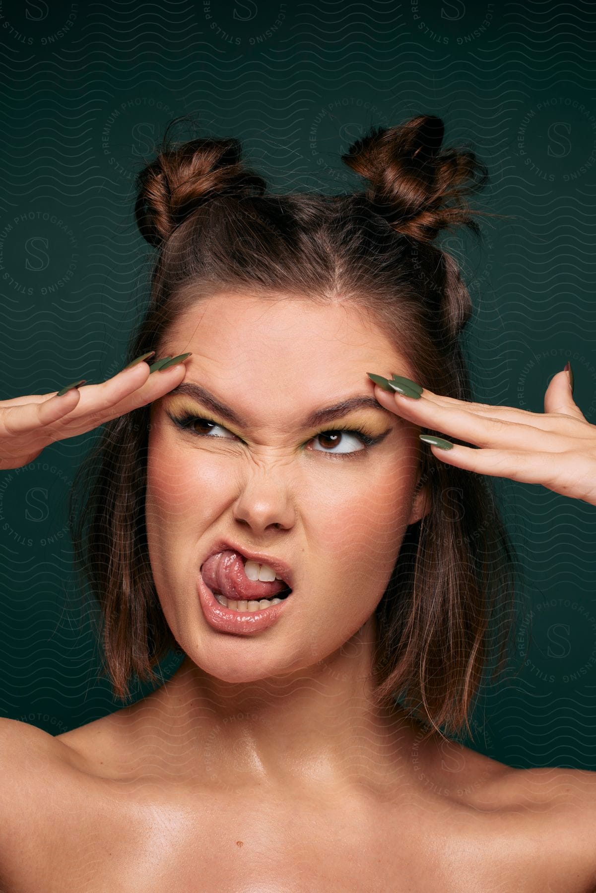 A young woman touching her forehead while making funny faces