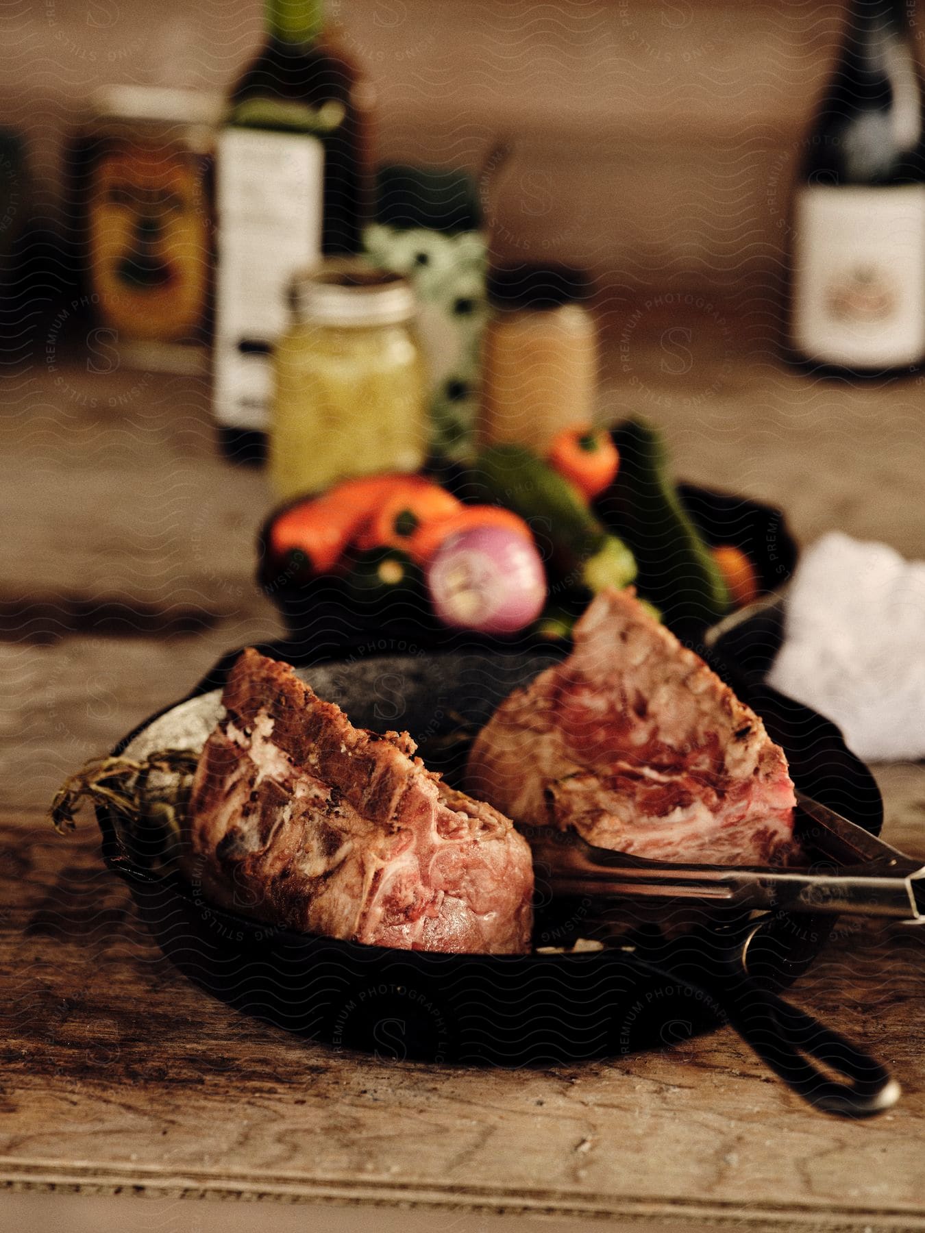 Bone-in lamb loins in a cast iron pan.