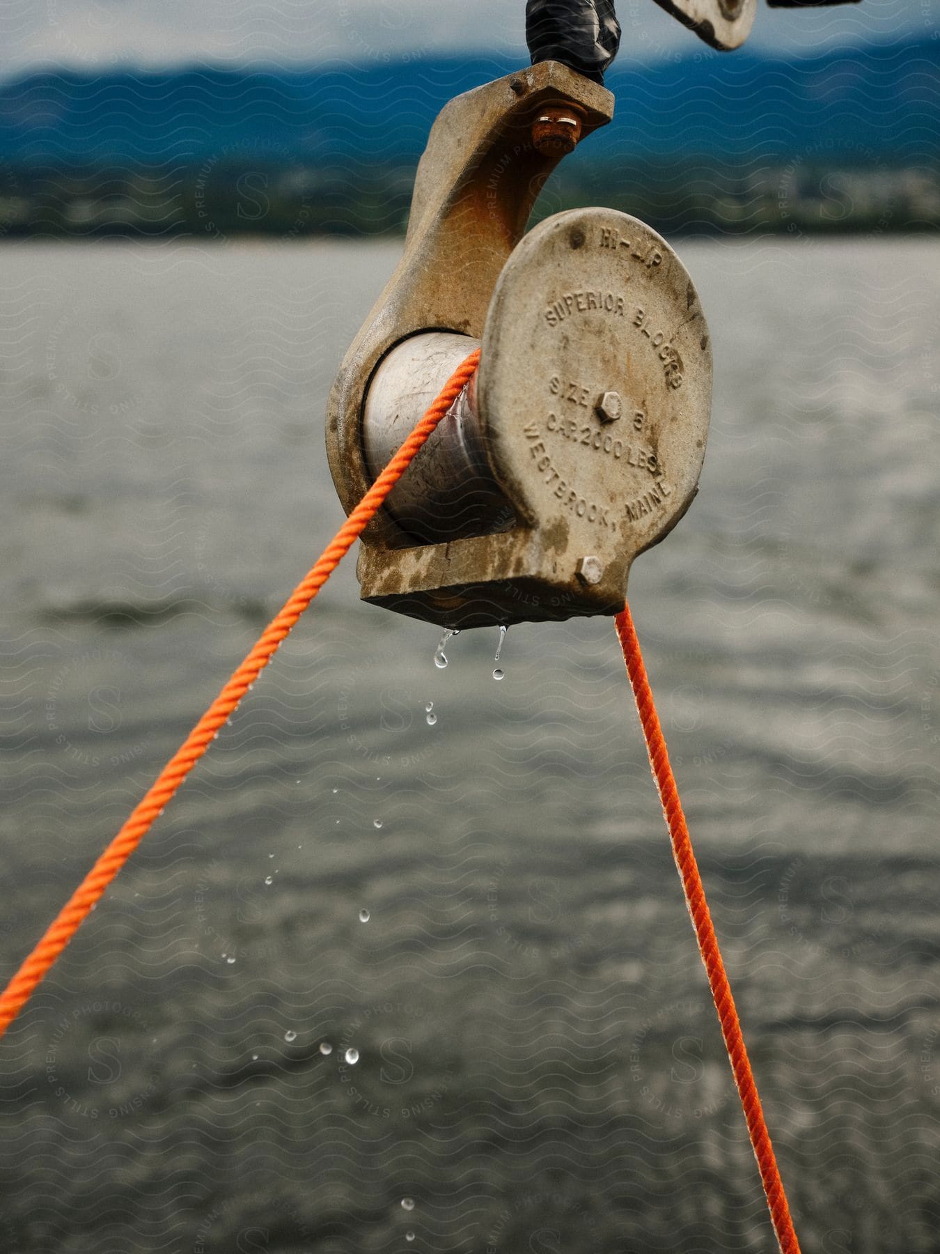 An orange rope on a boat winch.