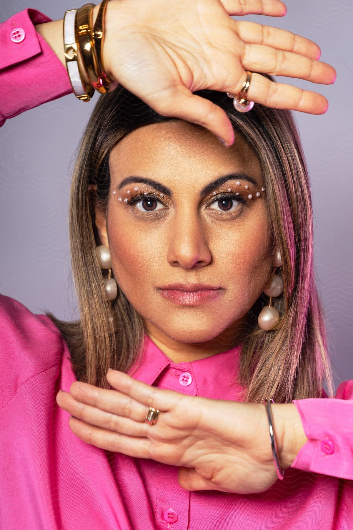 Portrait Of A Woman With Makeup And The Palms Of Her Hands Above And Below Her Face